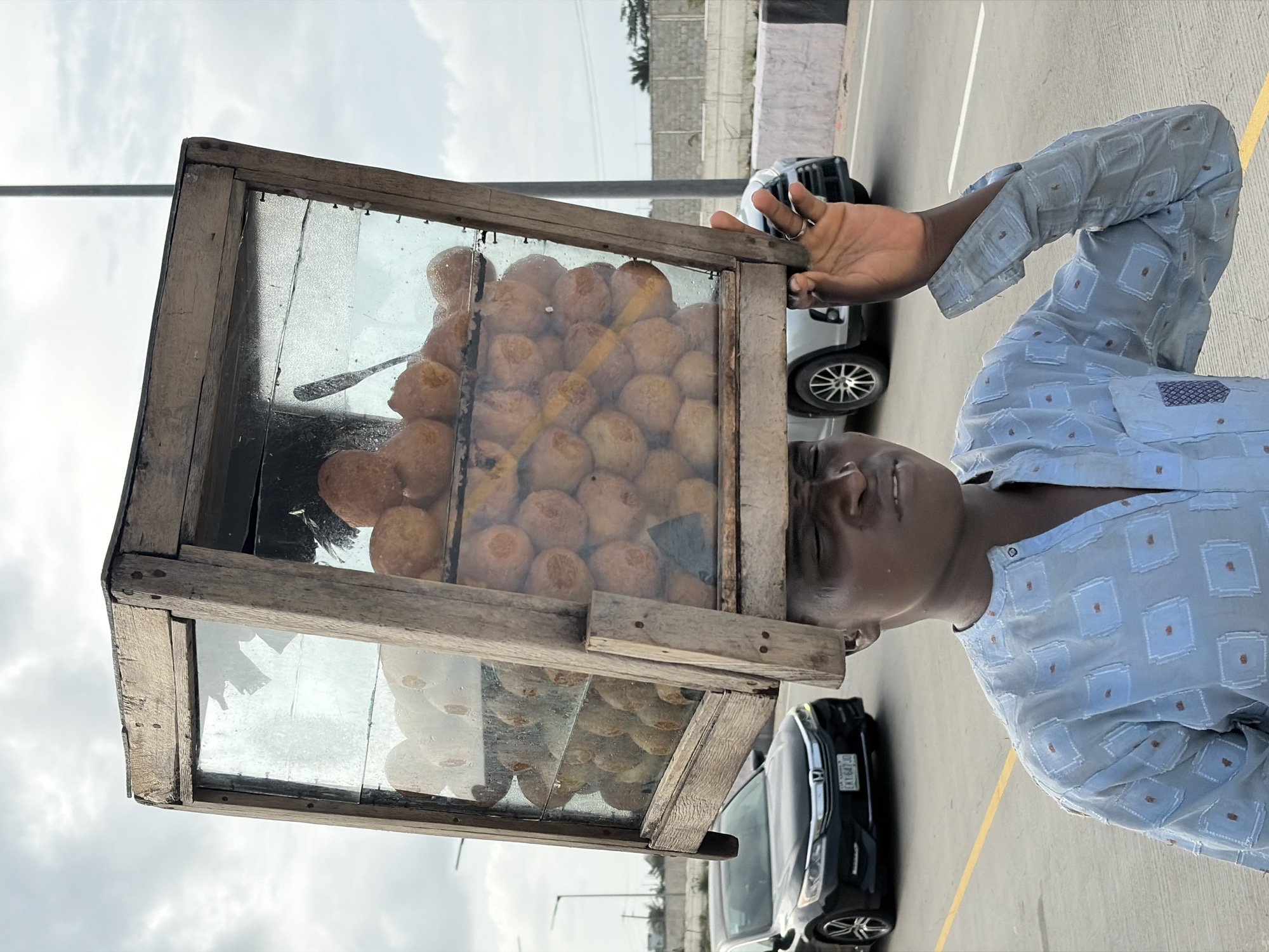 Street vendor and service vehicle on a Lagos-area road