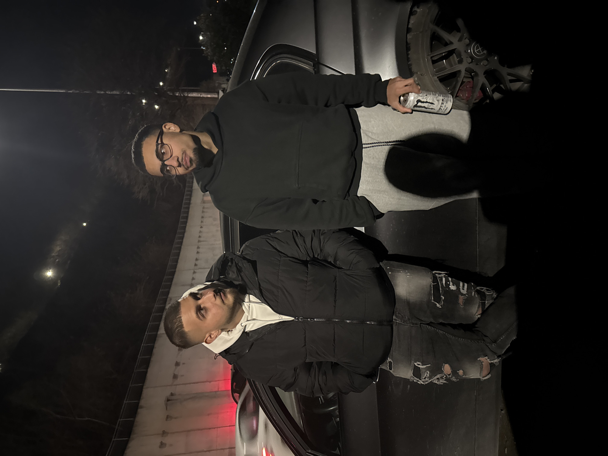 Two men pose for photo near car in Varna