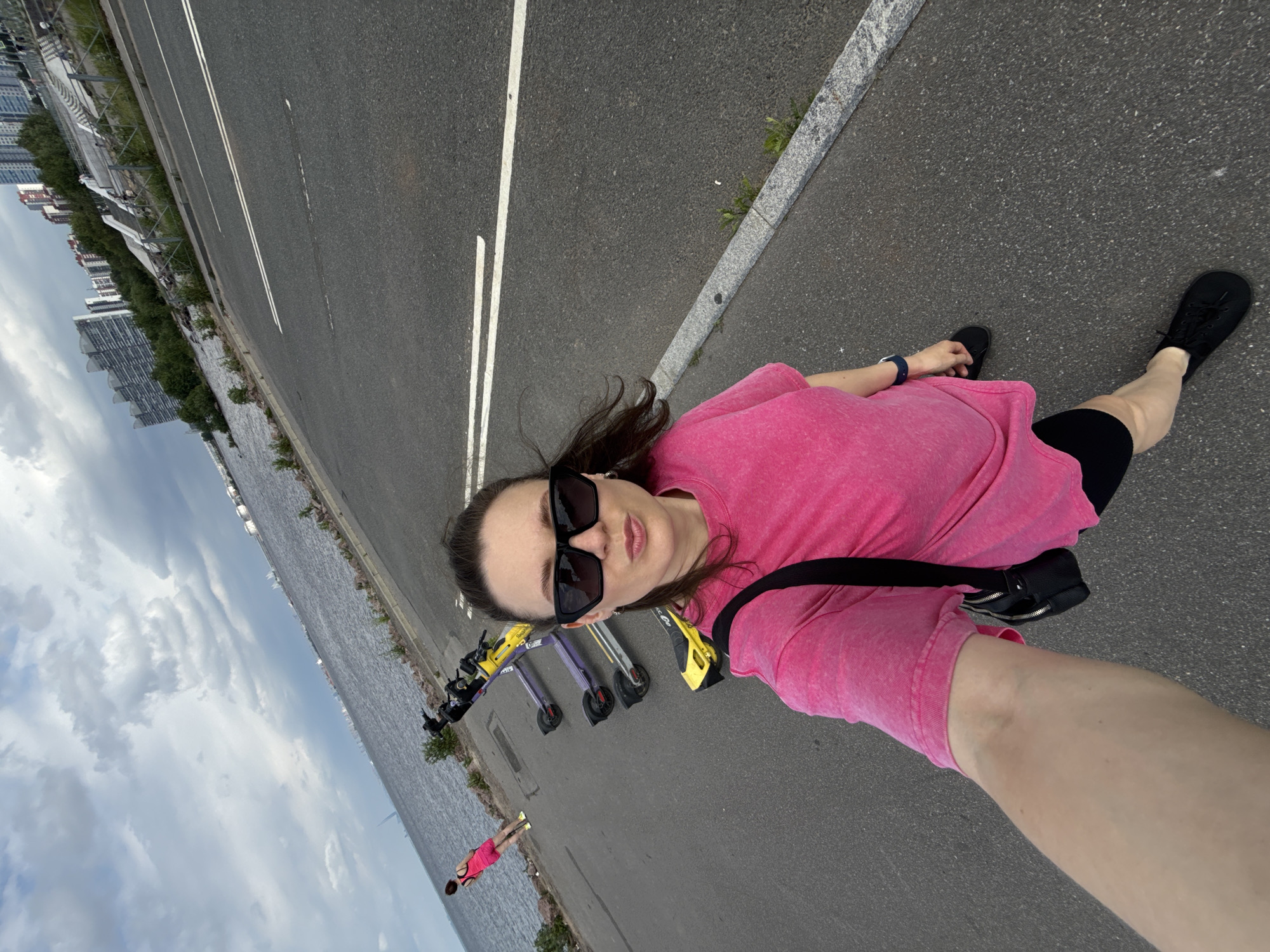 Woman Takes Multiple Selfies Along Saint Petersburg Waterfront Promenade