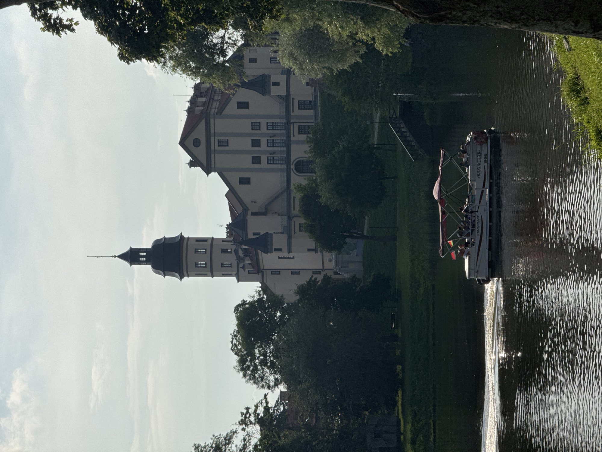 Afternoon at Nesvizh Castle: grounds, lake, and an outdoor event