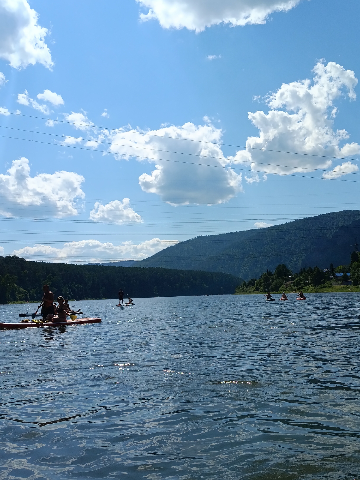 Summer day on the river at Усть-Мана — paddleboards, boats, and cliff jumpers