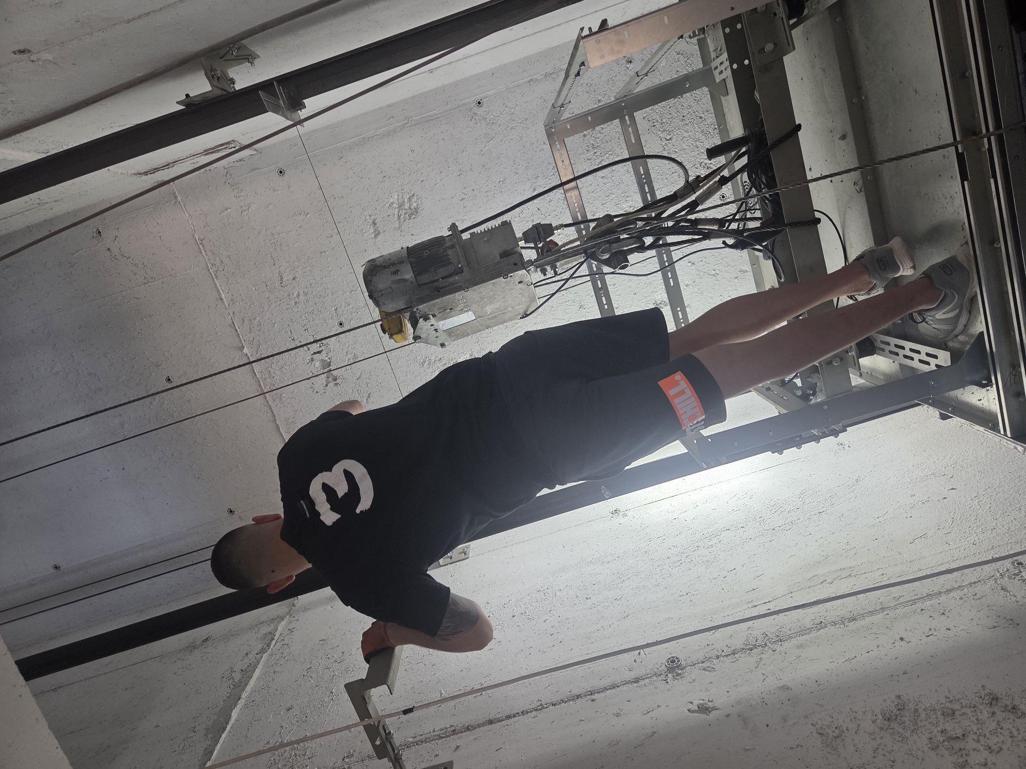 Maintenance work underway inside a suspended elevator shaft platform