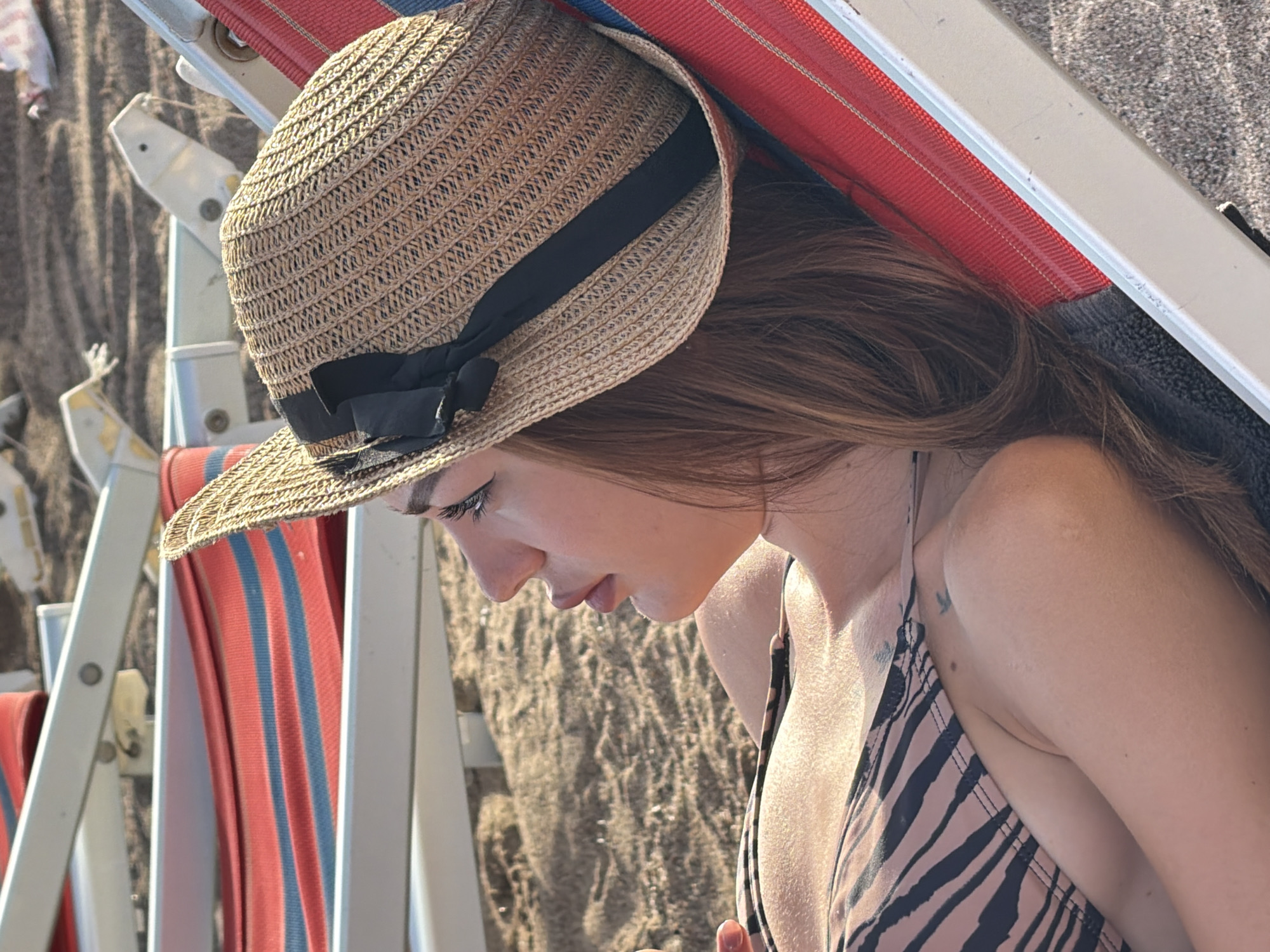 Woman enjoys late afternoon beach time in Boreti, Montenegro