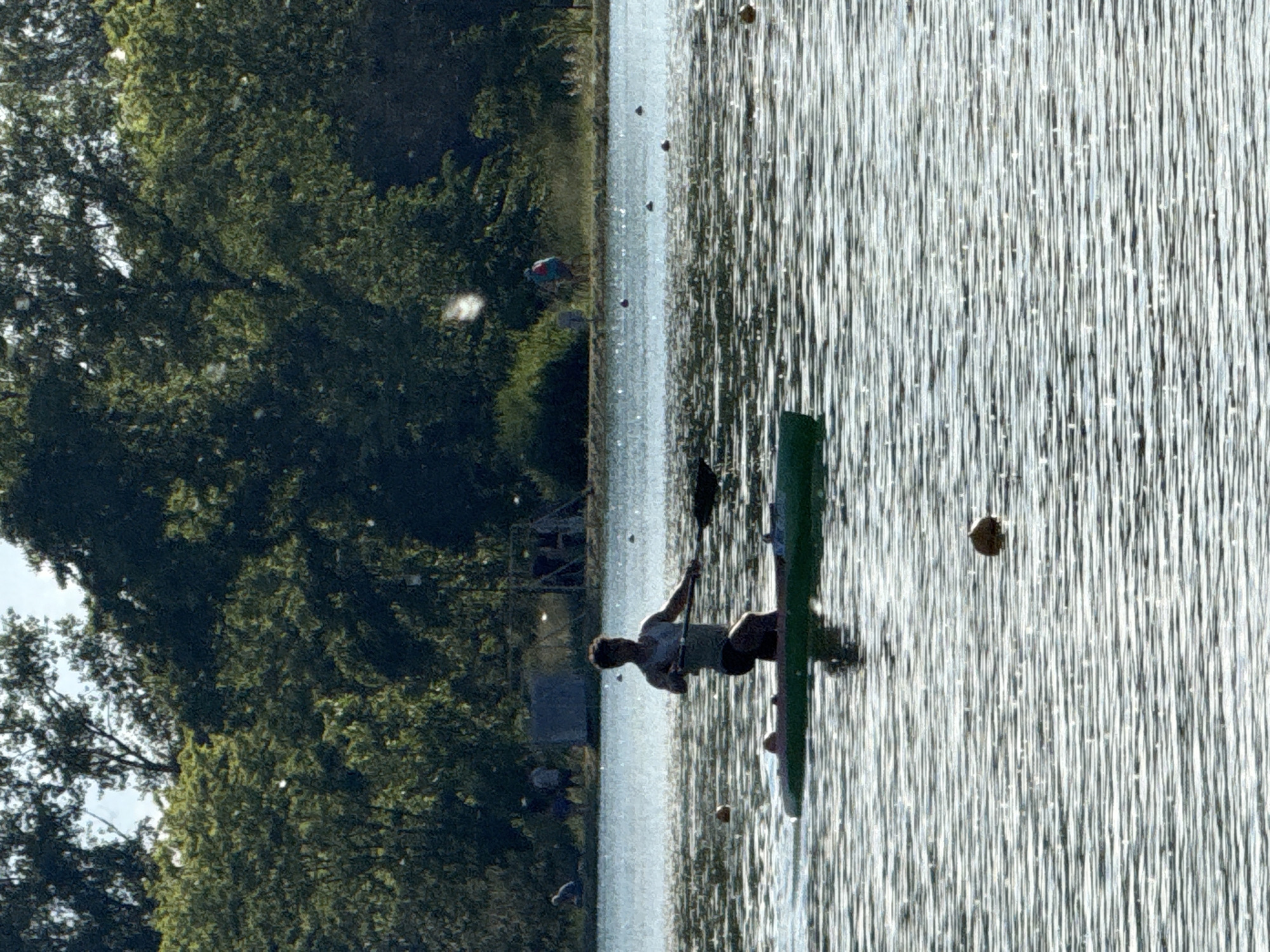 Recreational watercraft activity observed on sunny lake afternoon