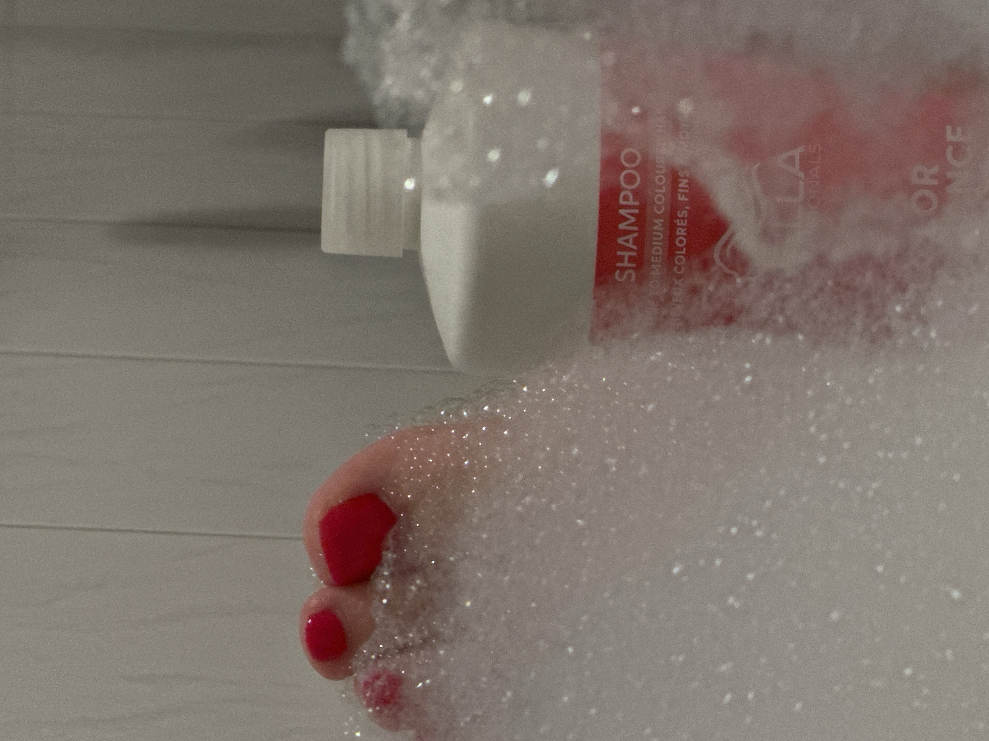 Red-painted toes in a bubble bath, Krefeld
