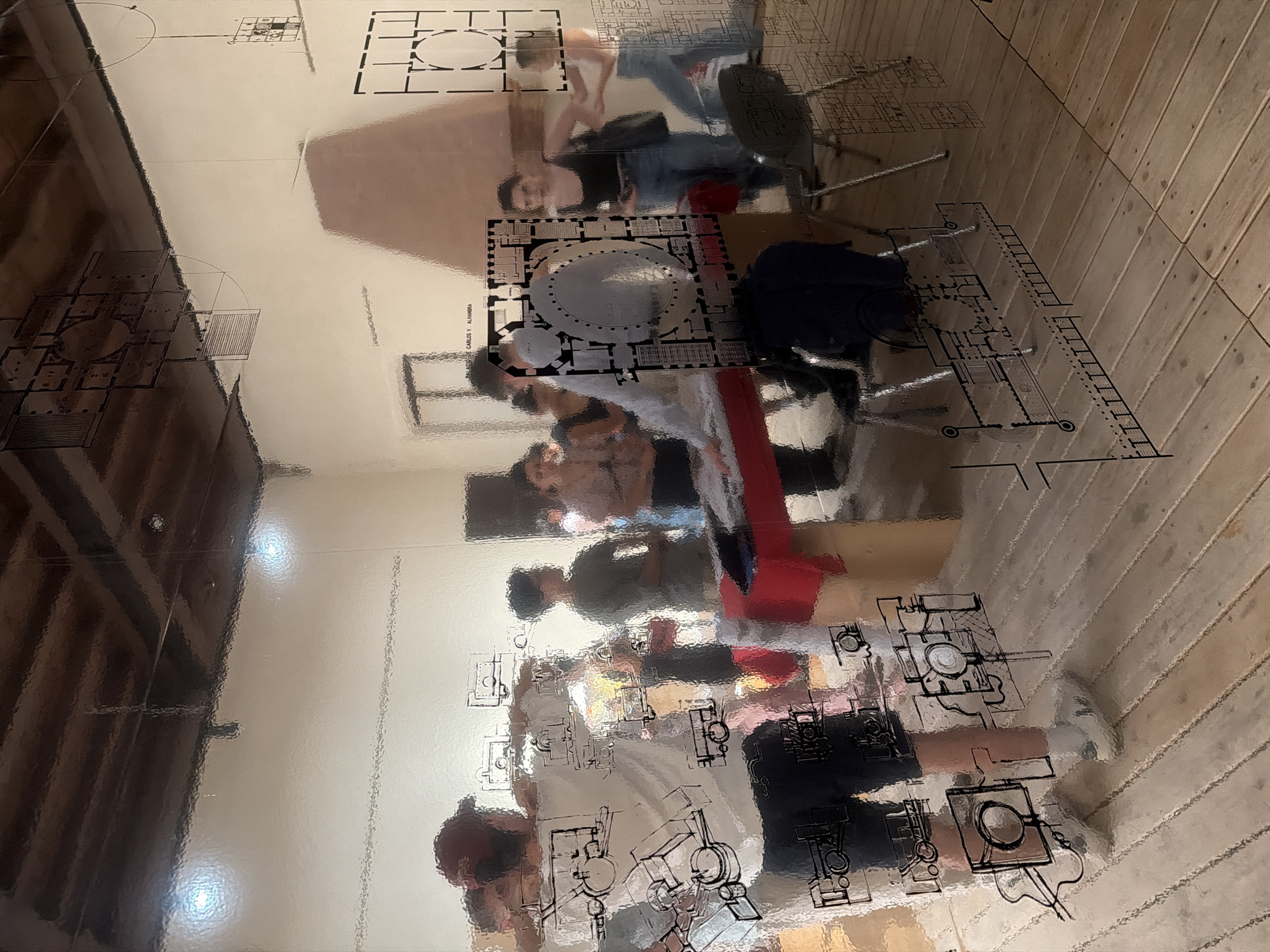 Architectural plans reflection captured in bright Mantua interior space