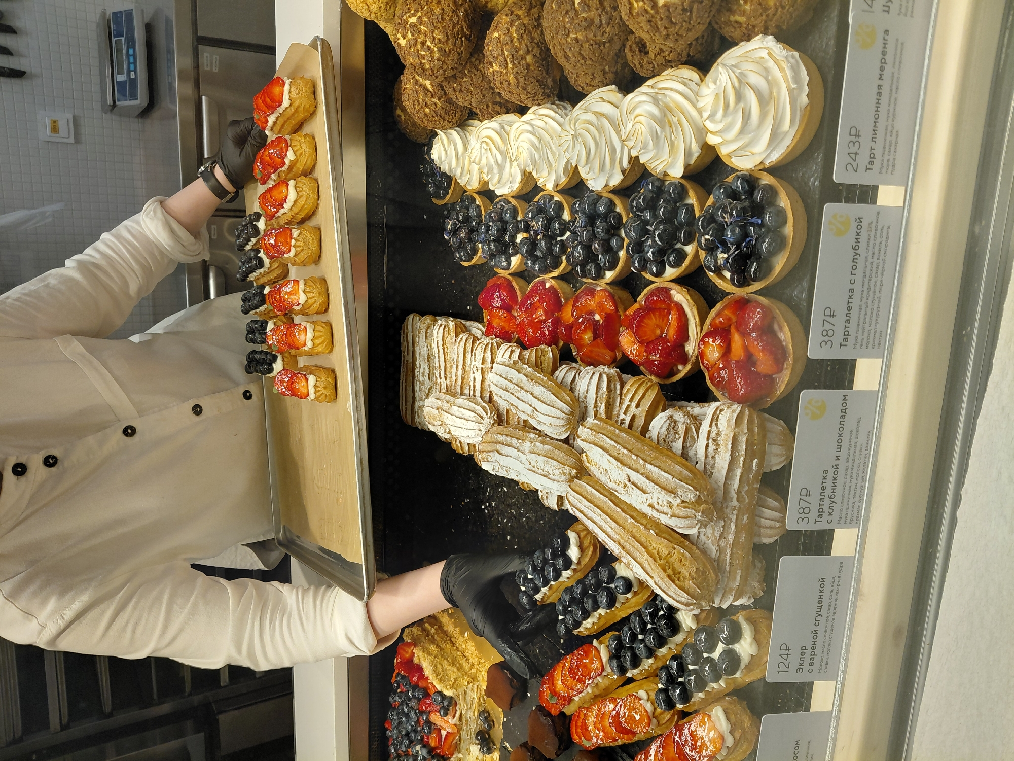 Fresh éclairs being prepped in a patisserie, plus a vintage Volga outside