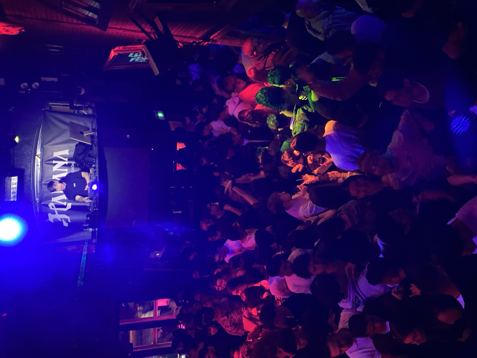 Packed nightclub scene captured in Gijón with DJ and lasers