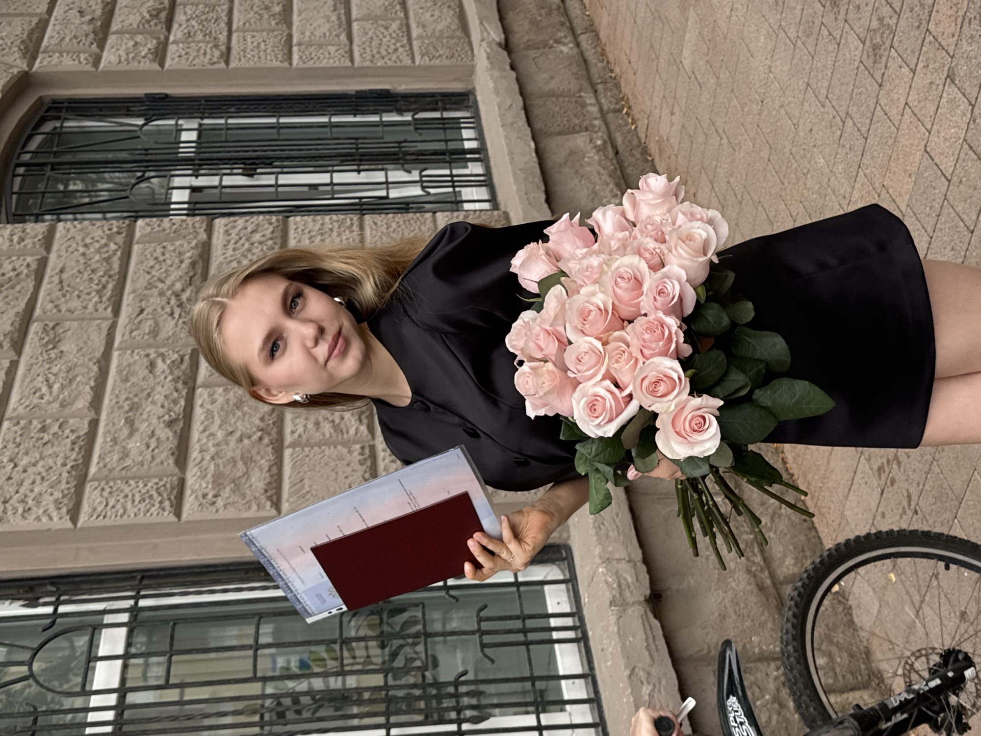Graduation day in Perm, roses and diploma in hand