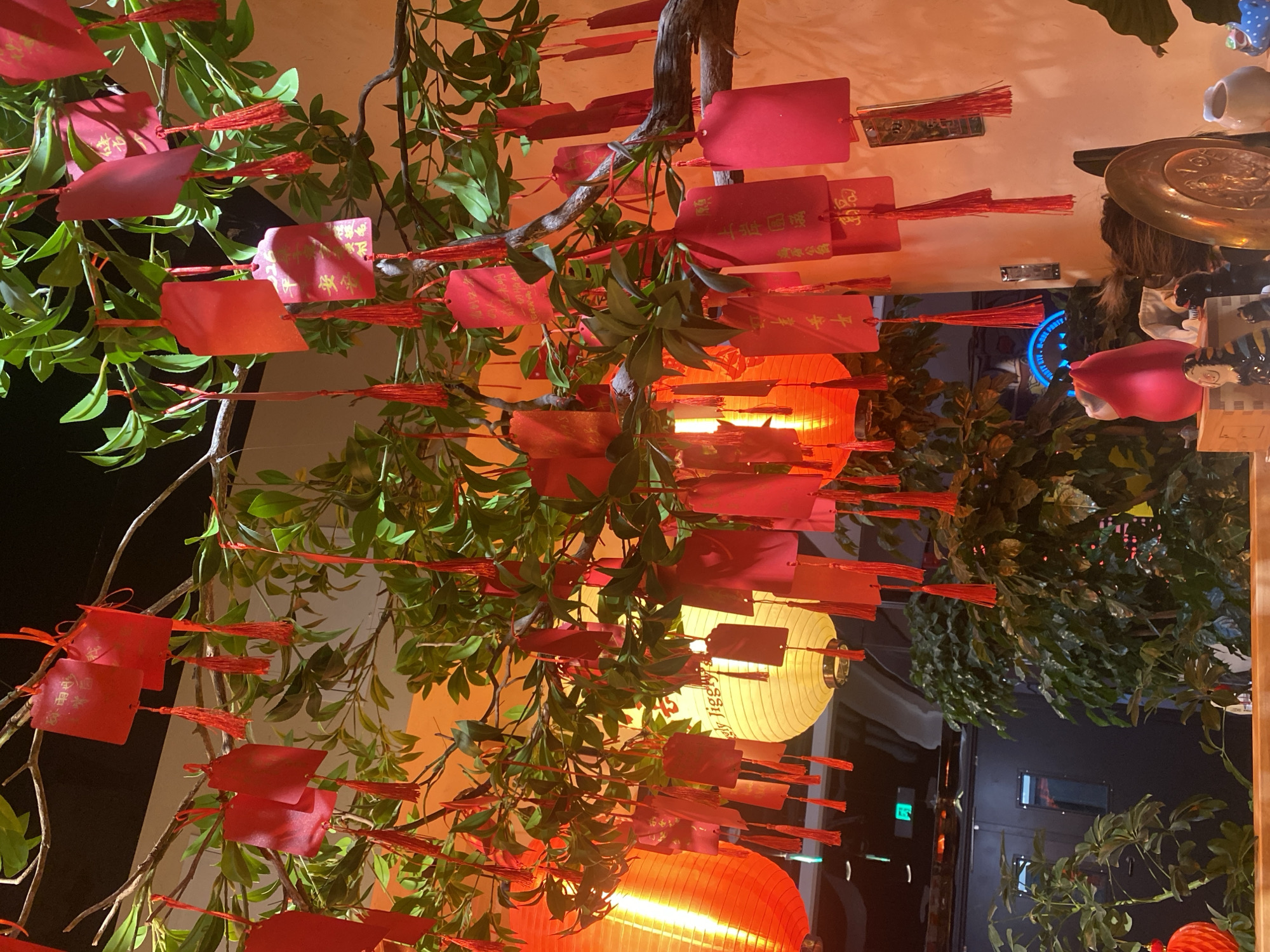 Indoor festival decorations with lanterns and ceramic cats observed