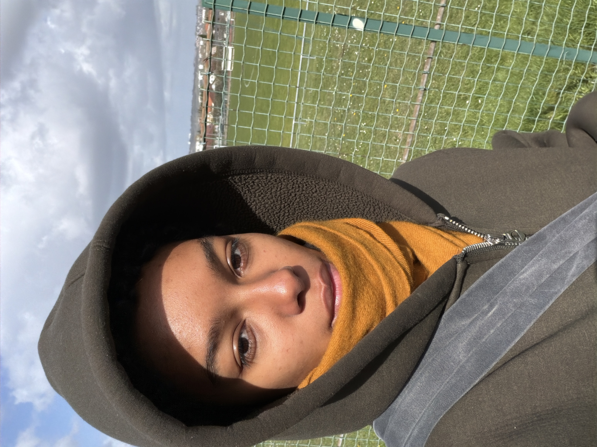 Person photographed in hoodie and scarf in Champs-sur-Marne