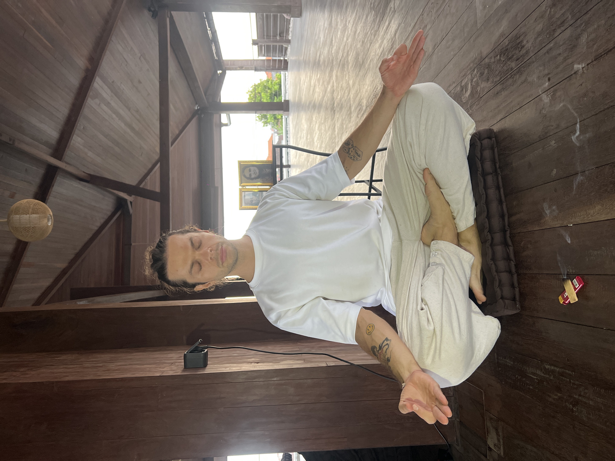 Man practices yoga at tropical resort in Mengwi, Indonesia