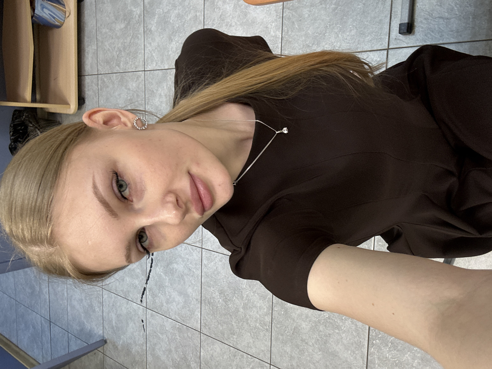Woman takes playful selfies in Perm office building