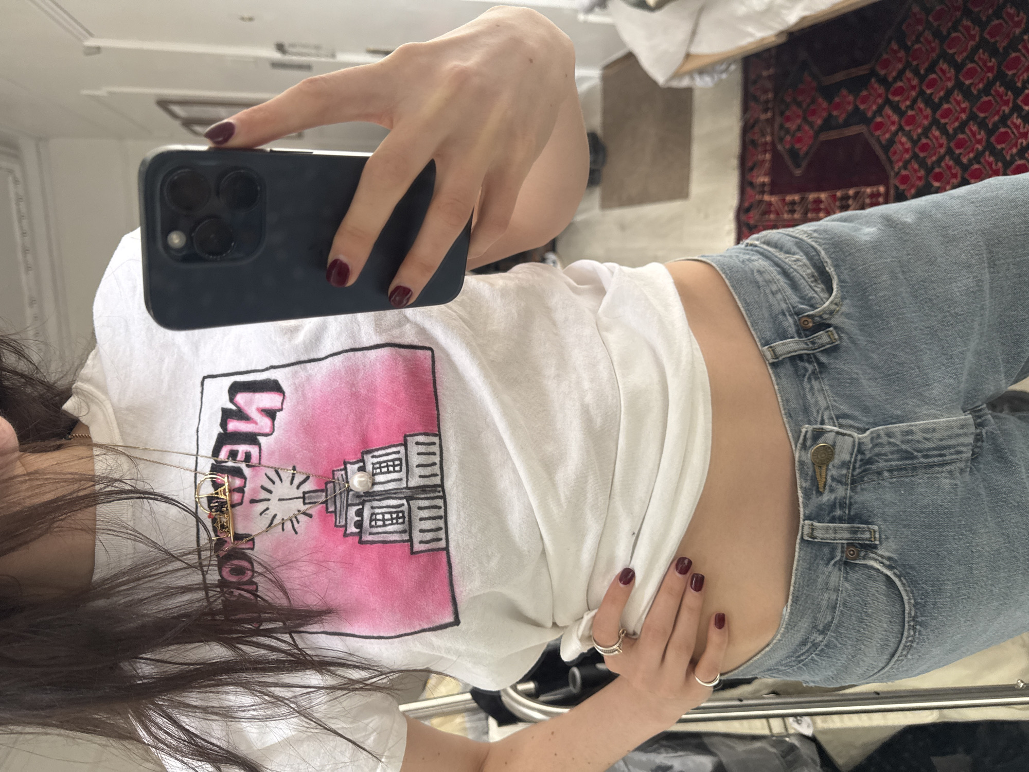 Woman takes selfies in Empire State Building shirt in NYC