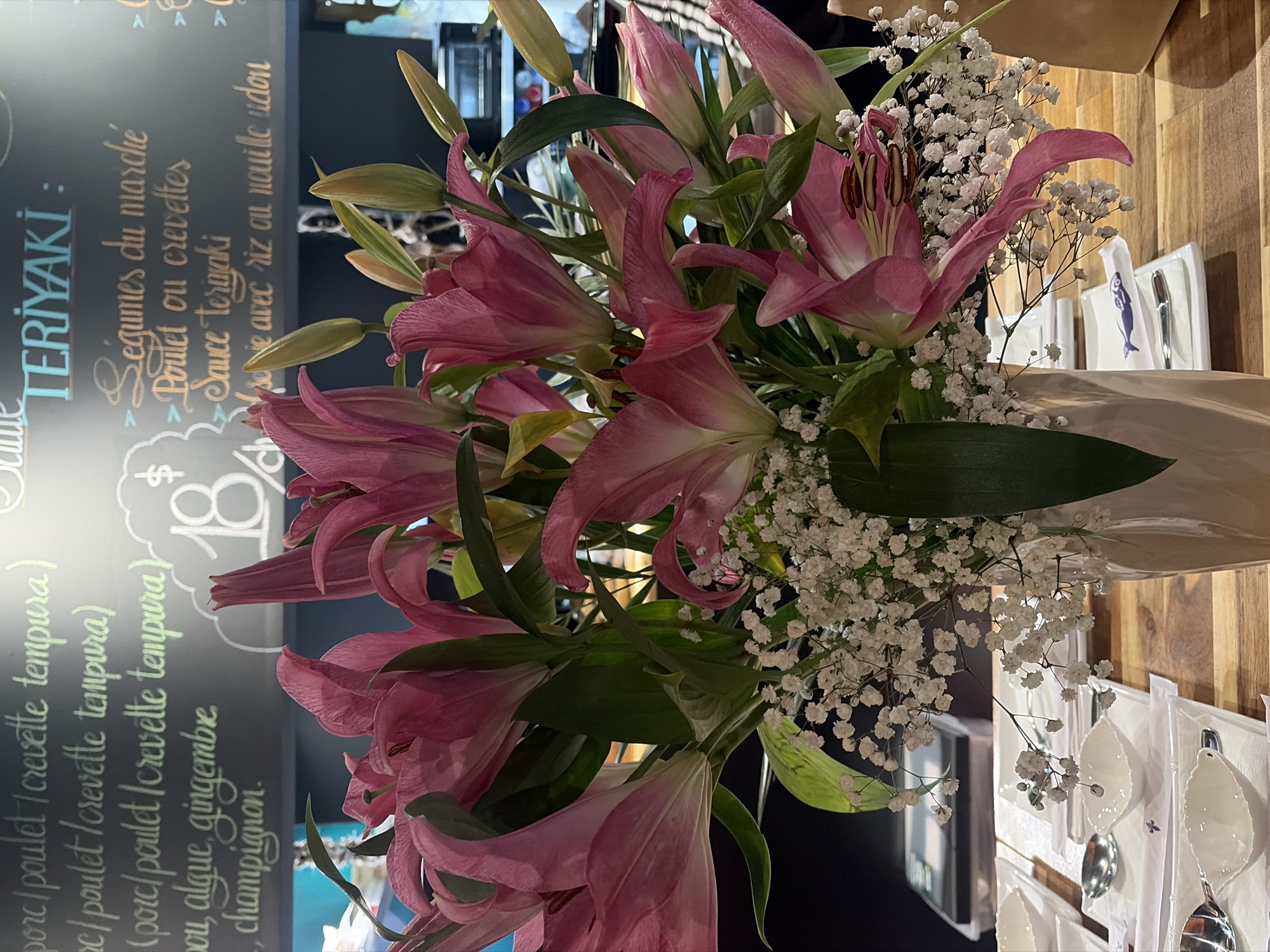 Pink lily bouquet displayed at Montreal restaurant teriyaki menu