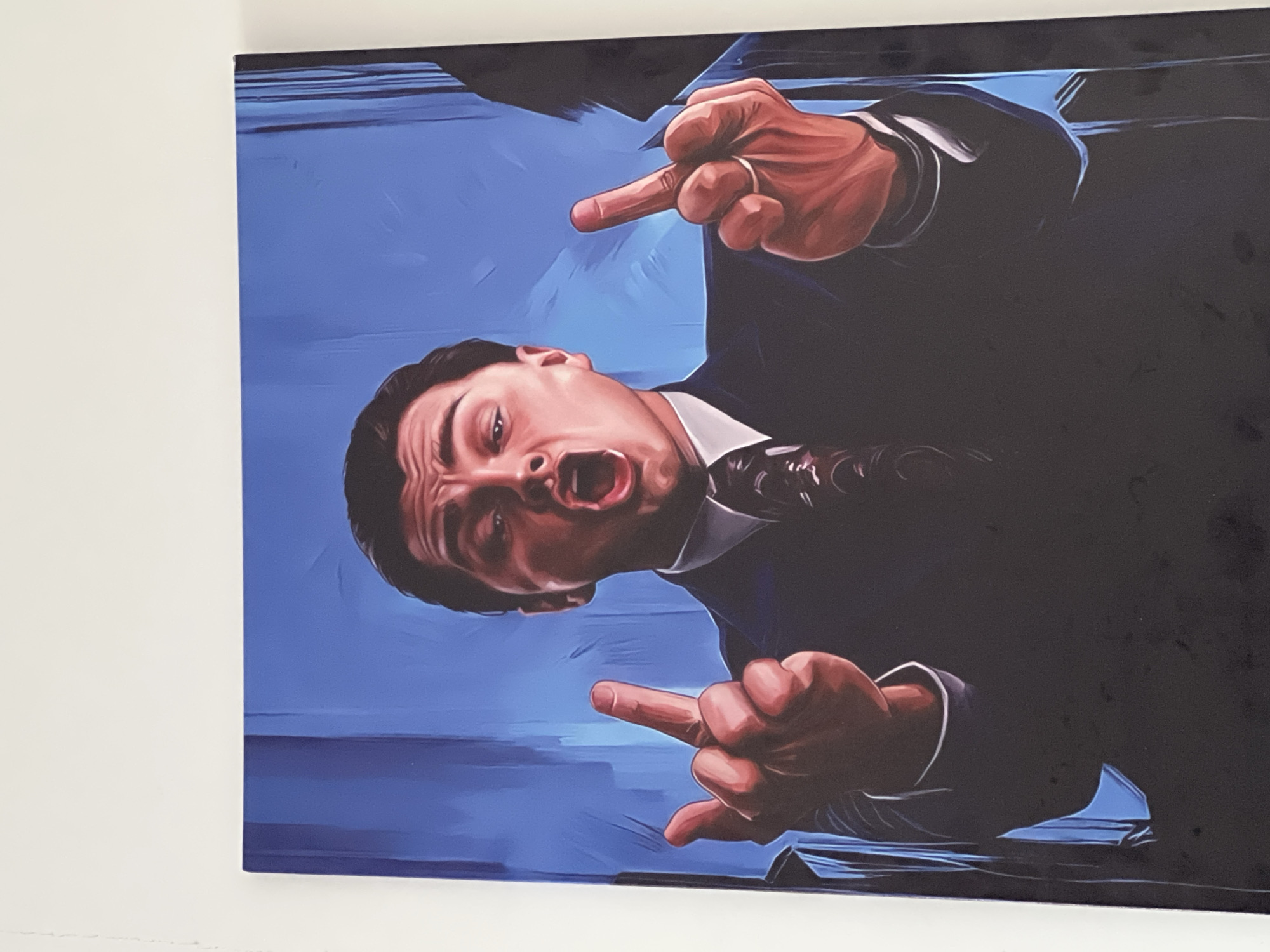Canvas artwork shows suited man making obscene gesture in Astana