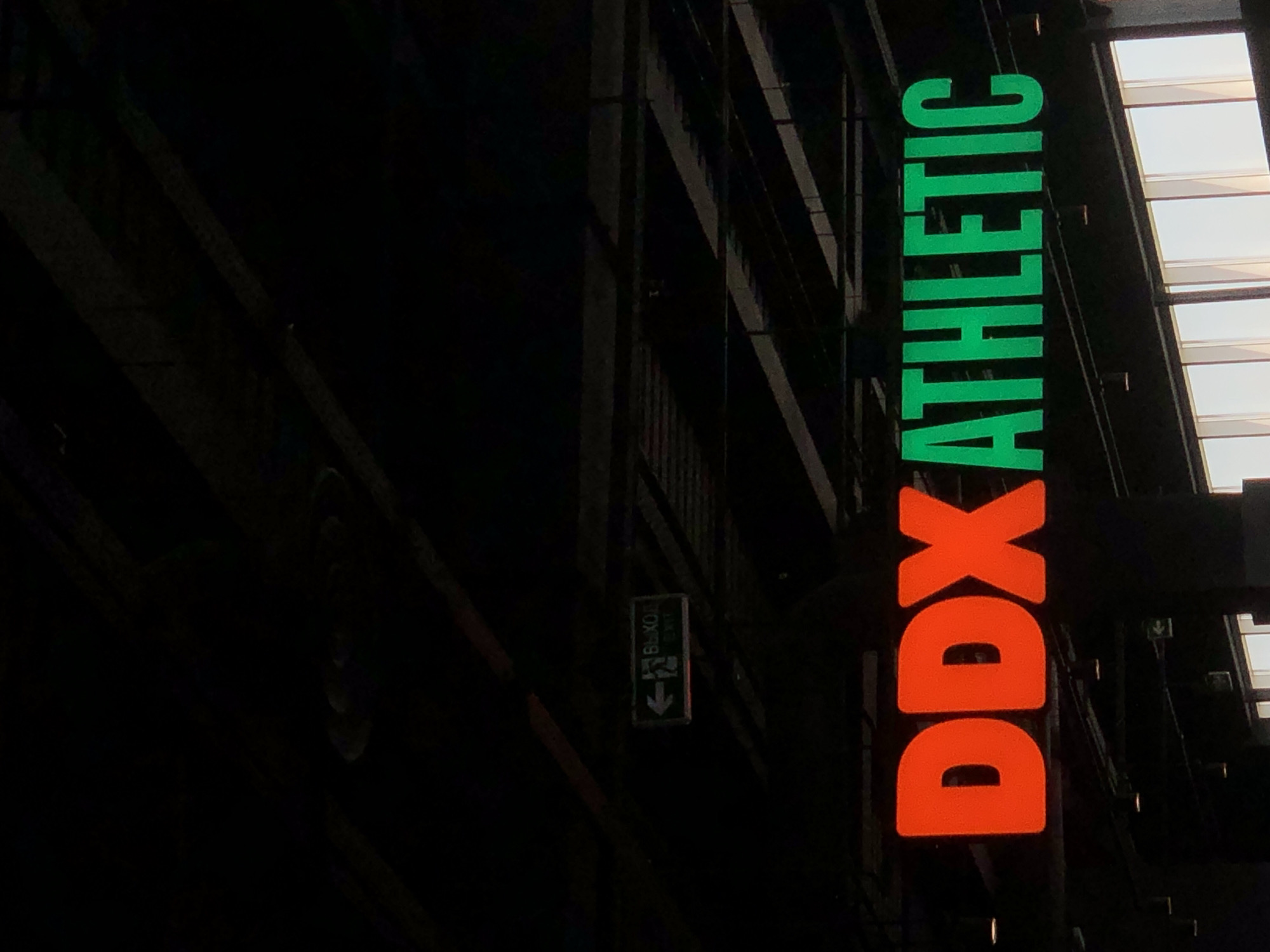 Illuminated DDX Athletic sign observed in Krasnoyarsk indoor venue