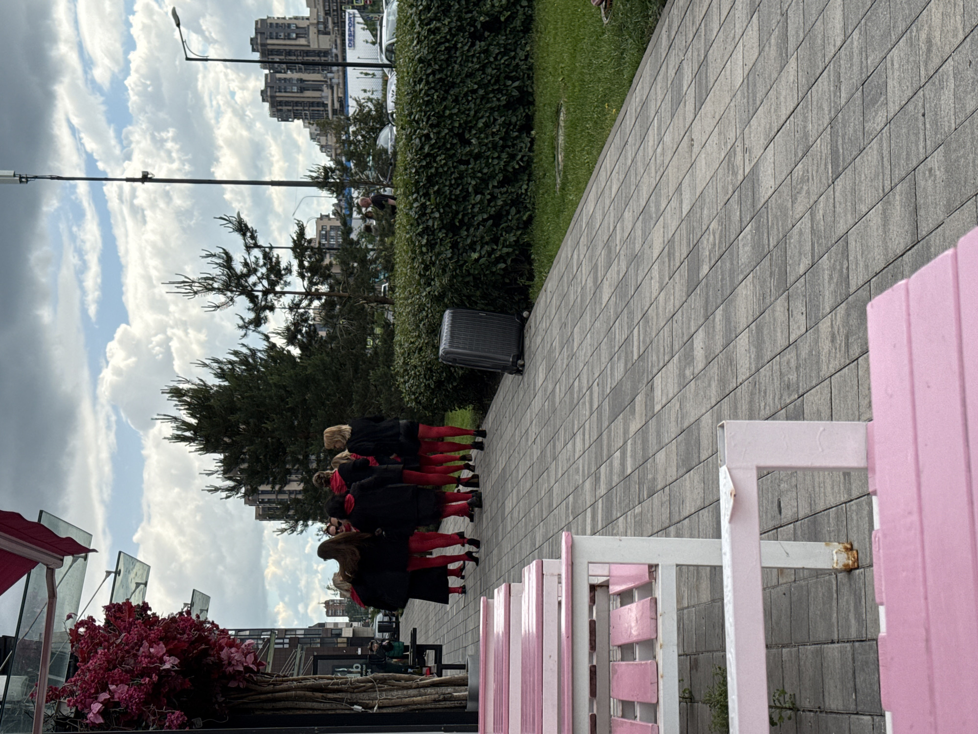 Red-themed group gathering in modern urban development with coffee stops