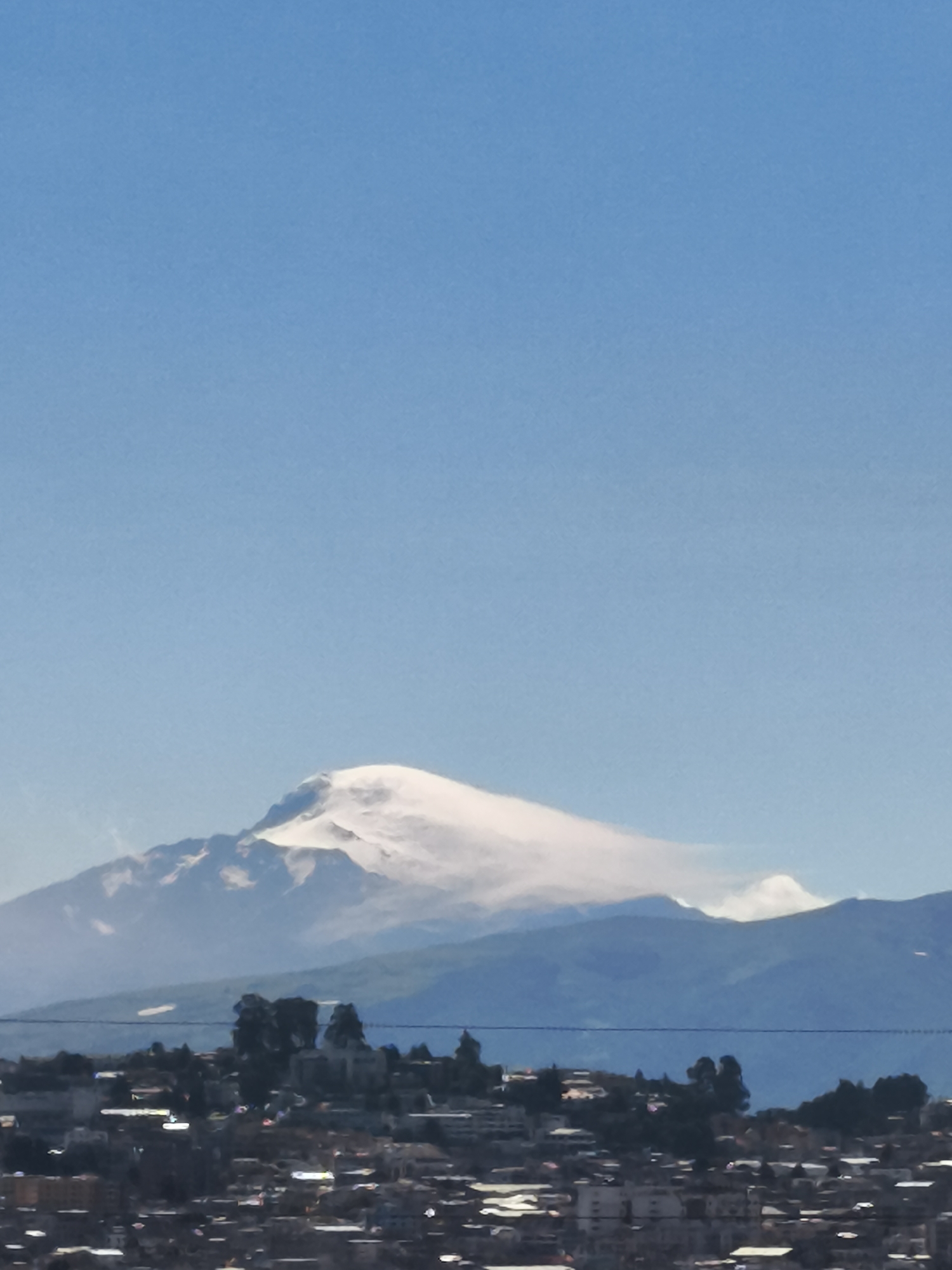 Clear mountain view captured over Quito's urban landscape