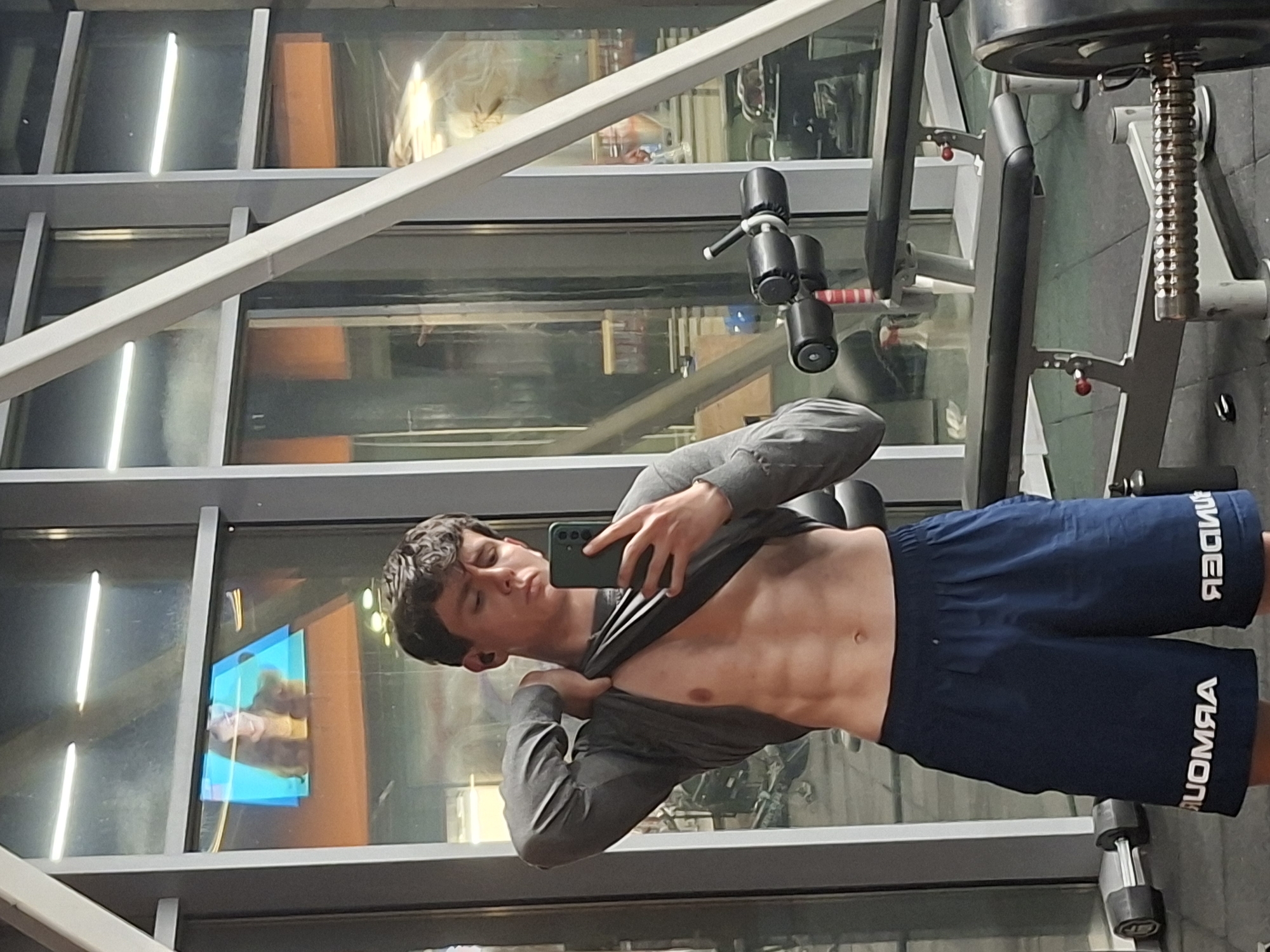 Young man takes mirror selfies at Plovdiv gym