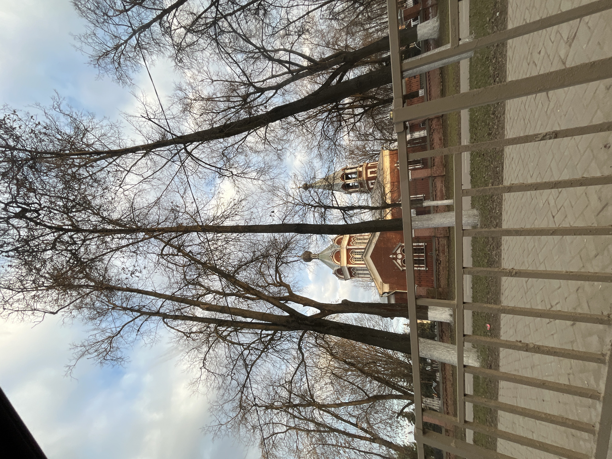 Red brick building photographed through fence in Klin, Russia