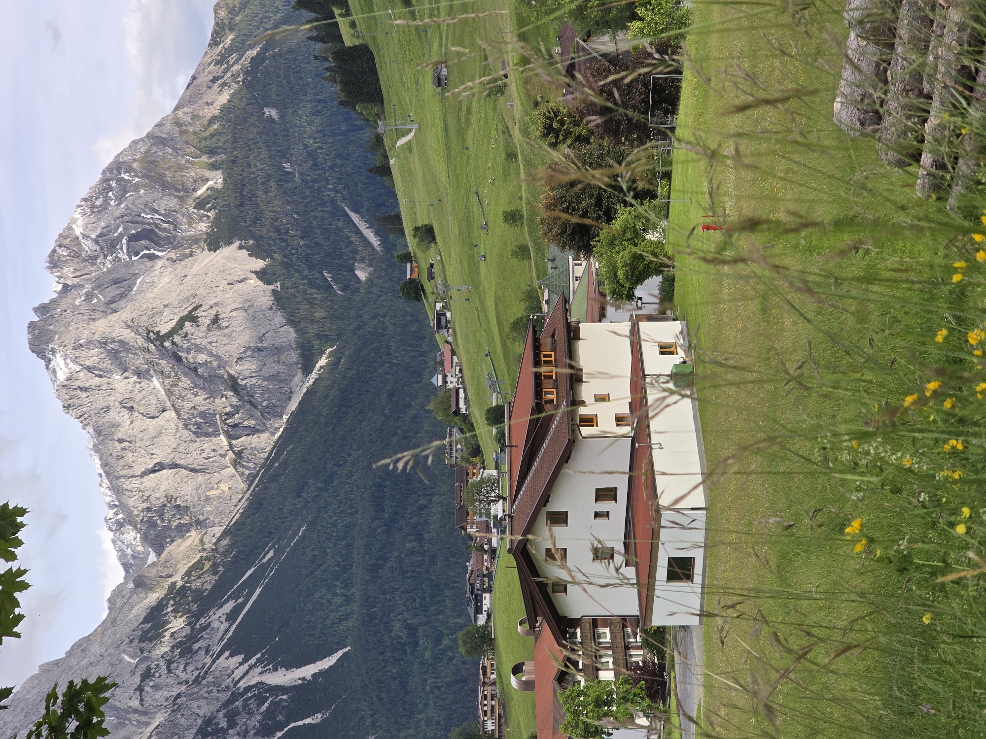 Alpine village Lermoos documented with trains, meadows, Zugspitze backdrop