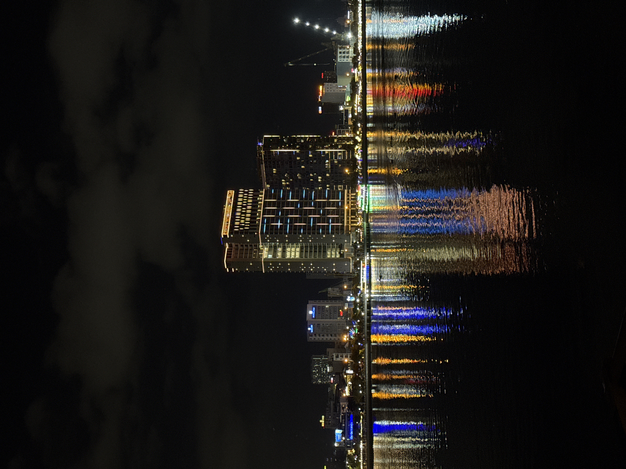 Nighttime Dragon Bridge and Han River illuminated in Da Nang