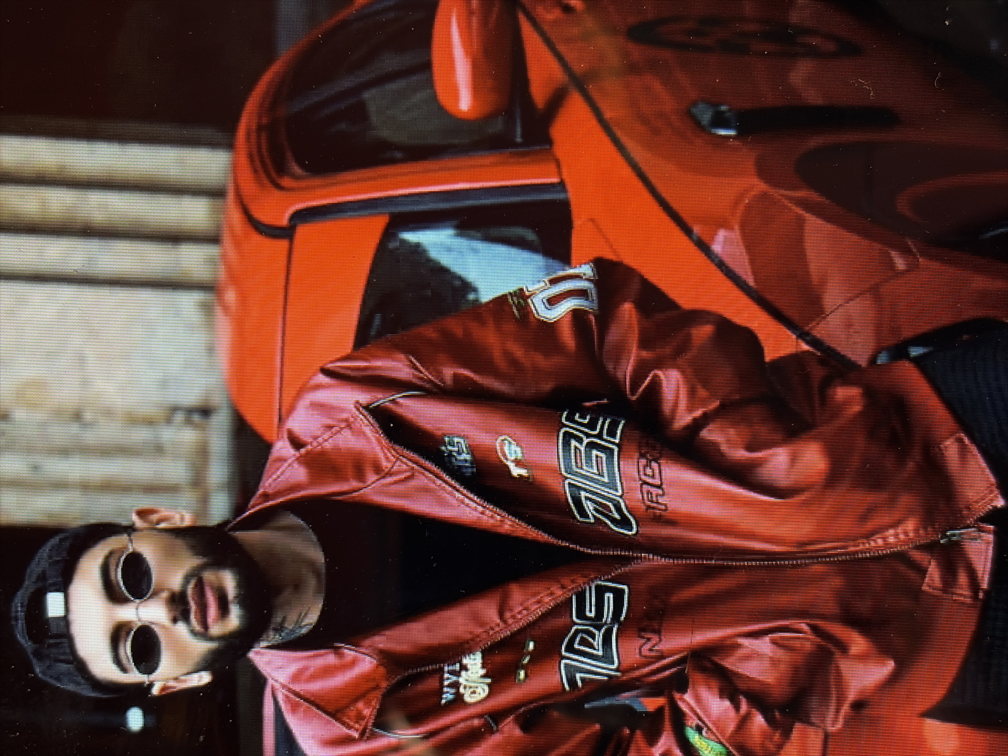 Man poses with red sports car in Charentsavan