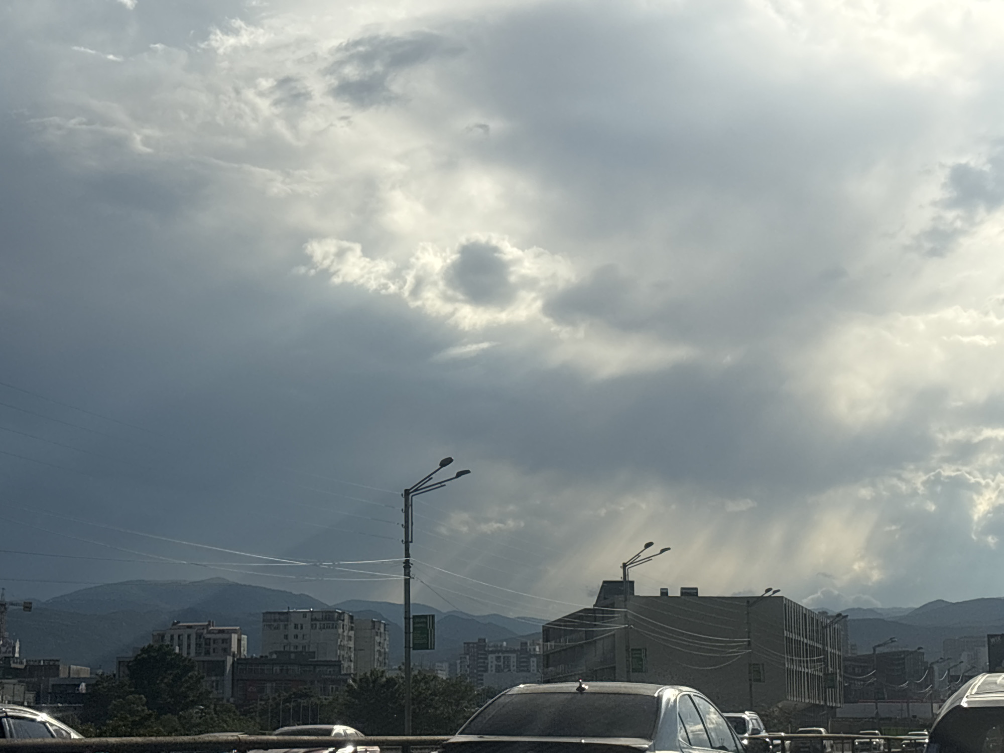 Tbilisi streets and skyline under a stormy afternoon sky
