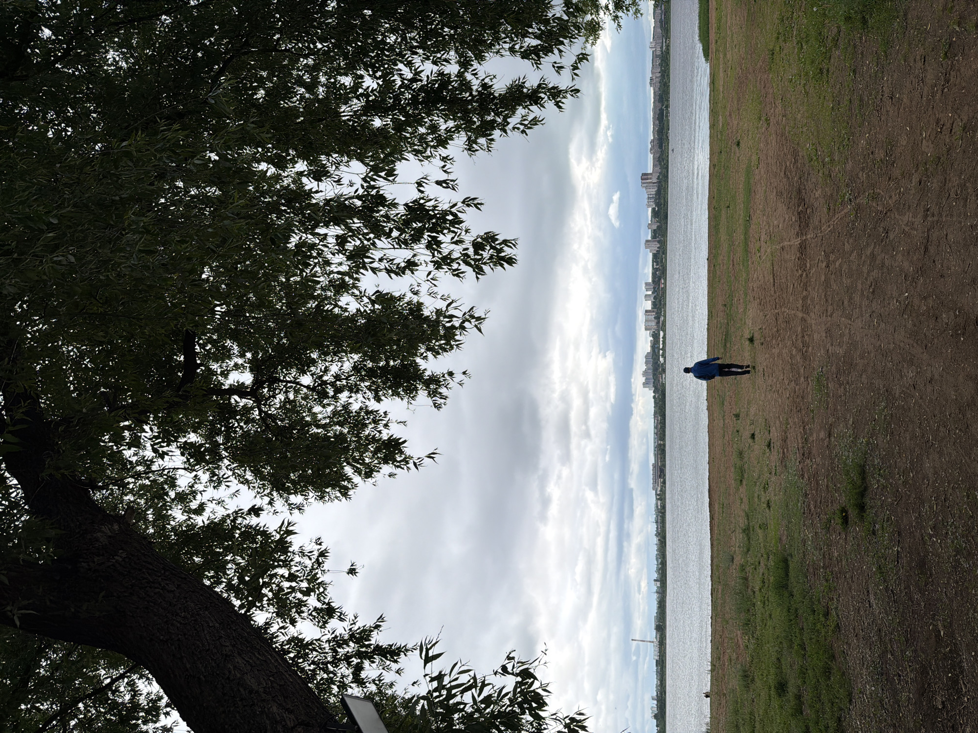Woman documents overcast day exploring Izhevsk parks and waterfront