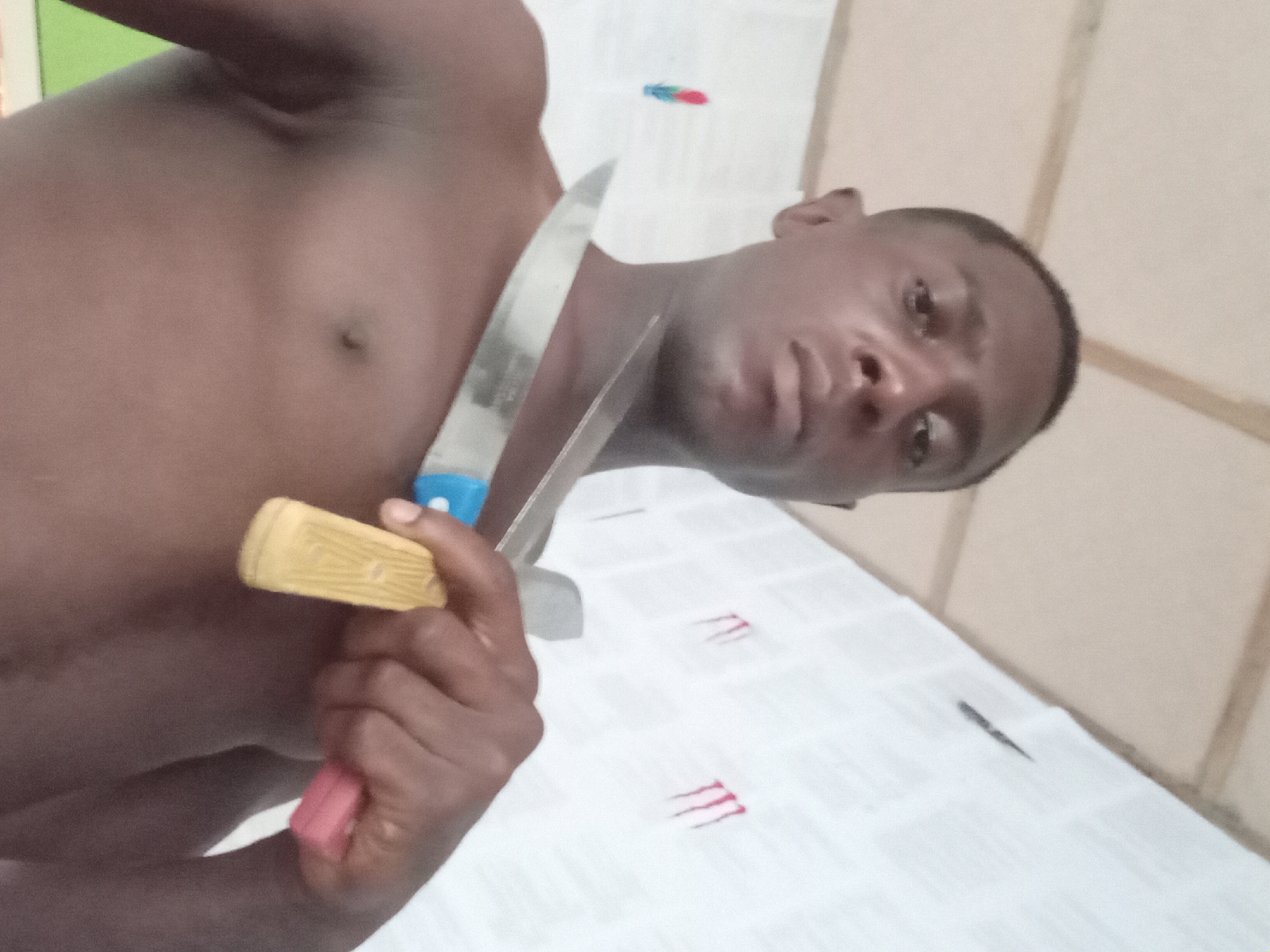 Man photographed in playful indoor session in Akwete, Nigeria