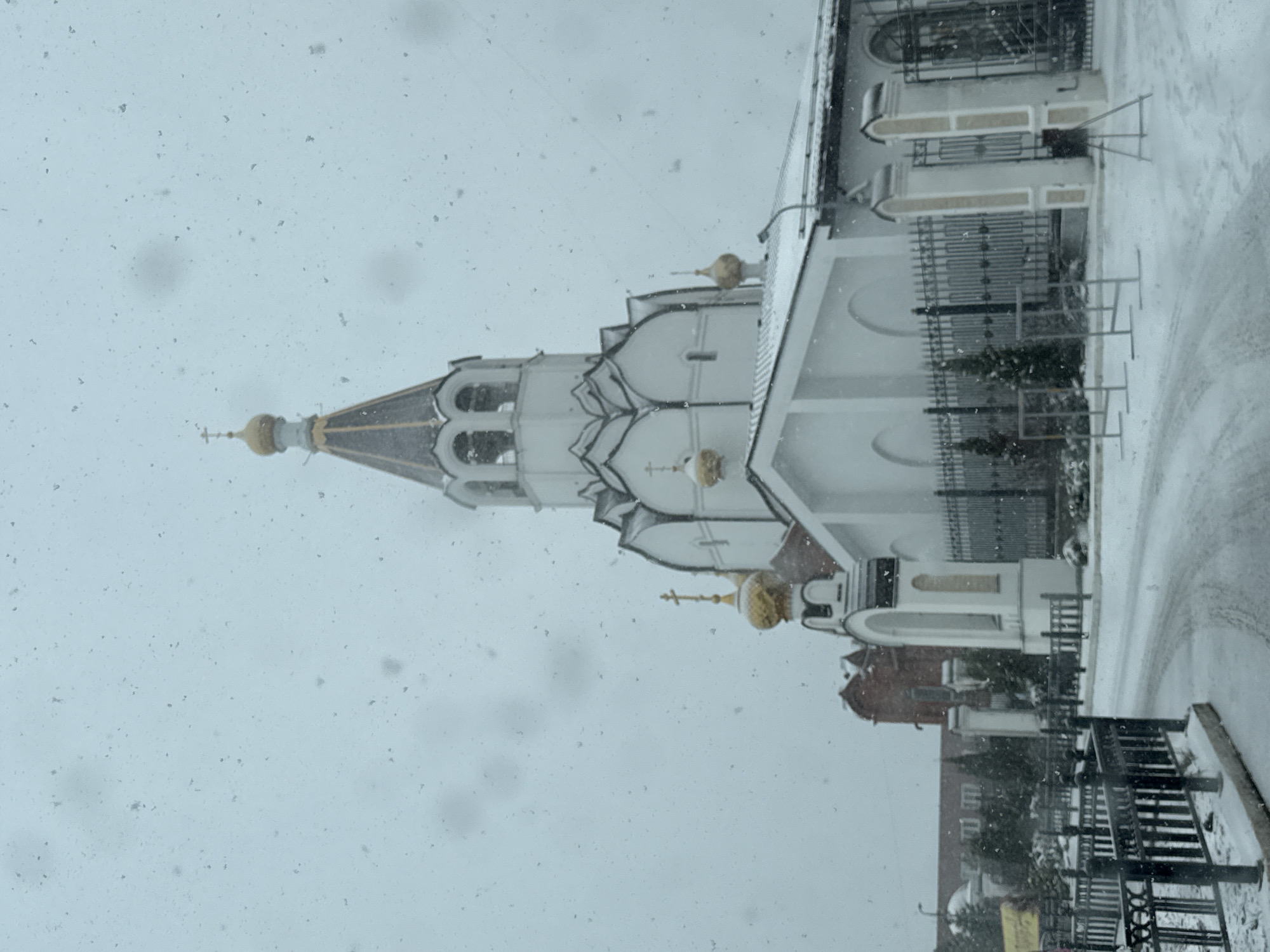 Spring snowfall blankets Orthodox church complex in Perm, Russia