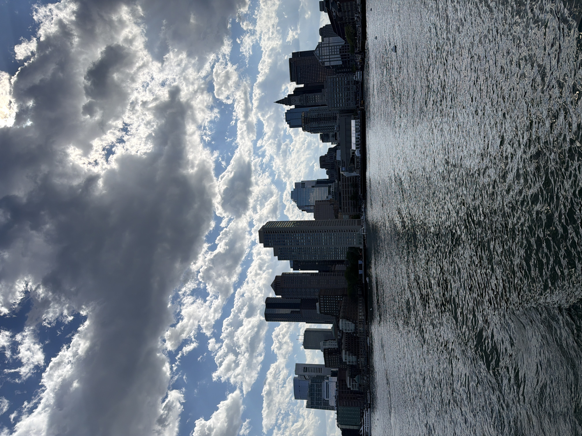 Boston skyline captured from harbor on cloudy evening
