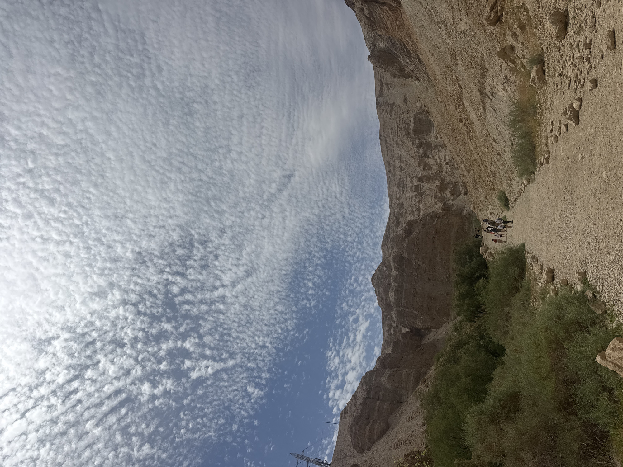 Hikers traverse canyon and water features in Israeli desert