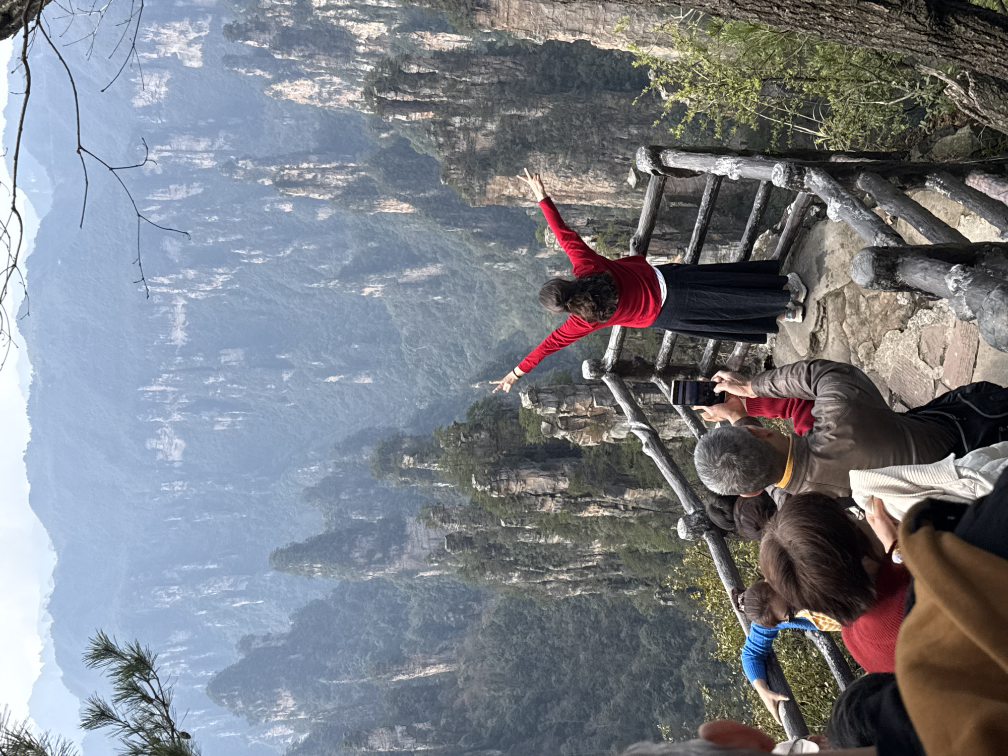 Tourists photograph Zhangjiajie's sandstone pillars at scenic viewpoints