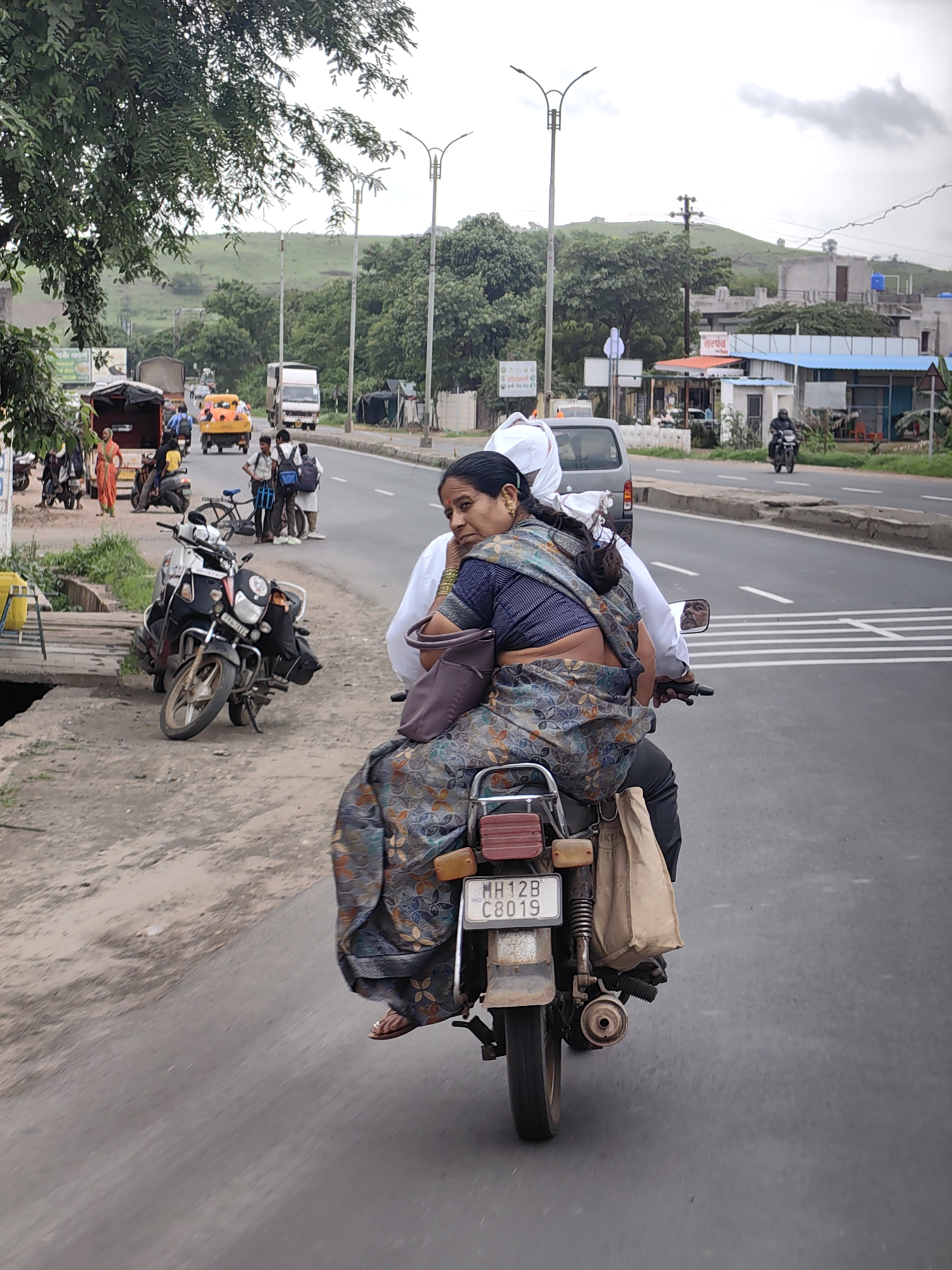 Motorcycle ride through Kedgaon streets on a cloudy day