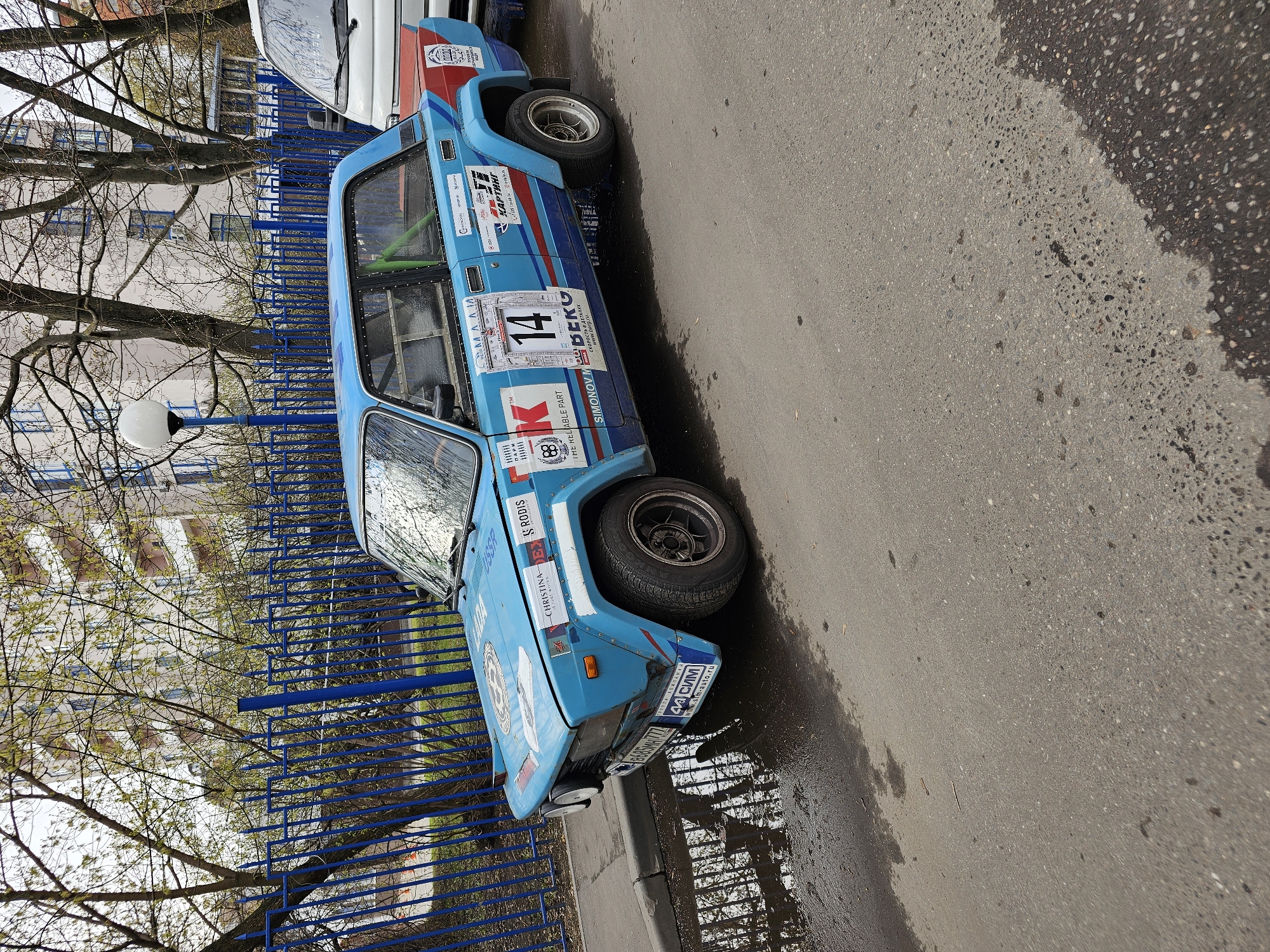 Rally car spotted on urban street amid spring scenes