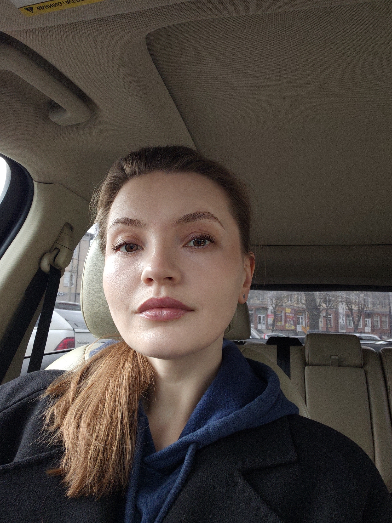 Woman in dark coat observed in driver's seat