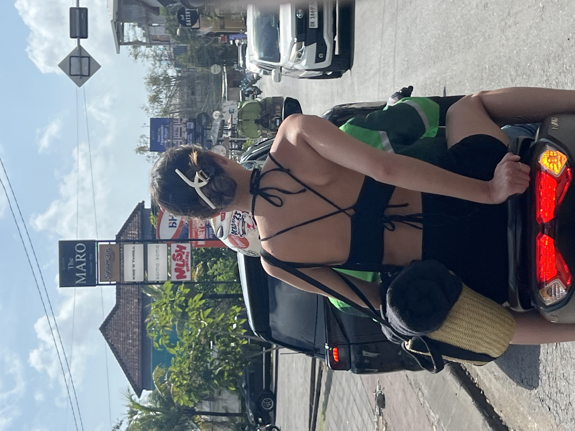 Scooter in traffic on a sunny Kuta Selatan street