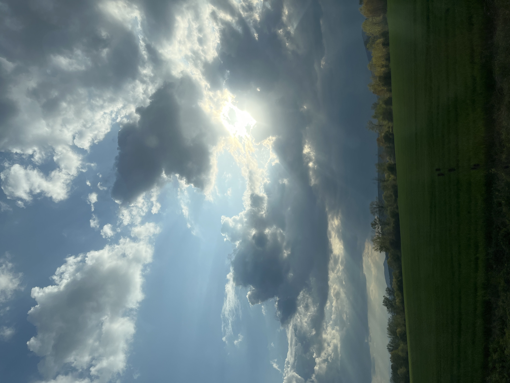 Sunbeams pierce cloudy sky over Bulgarian countryside