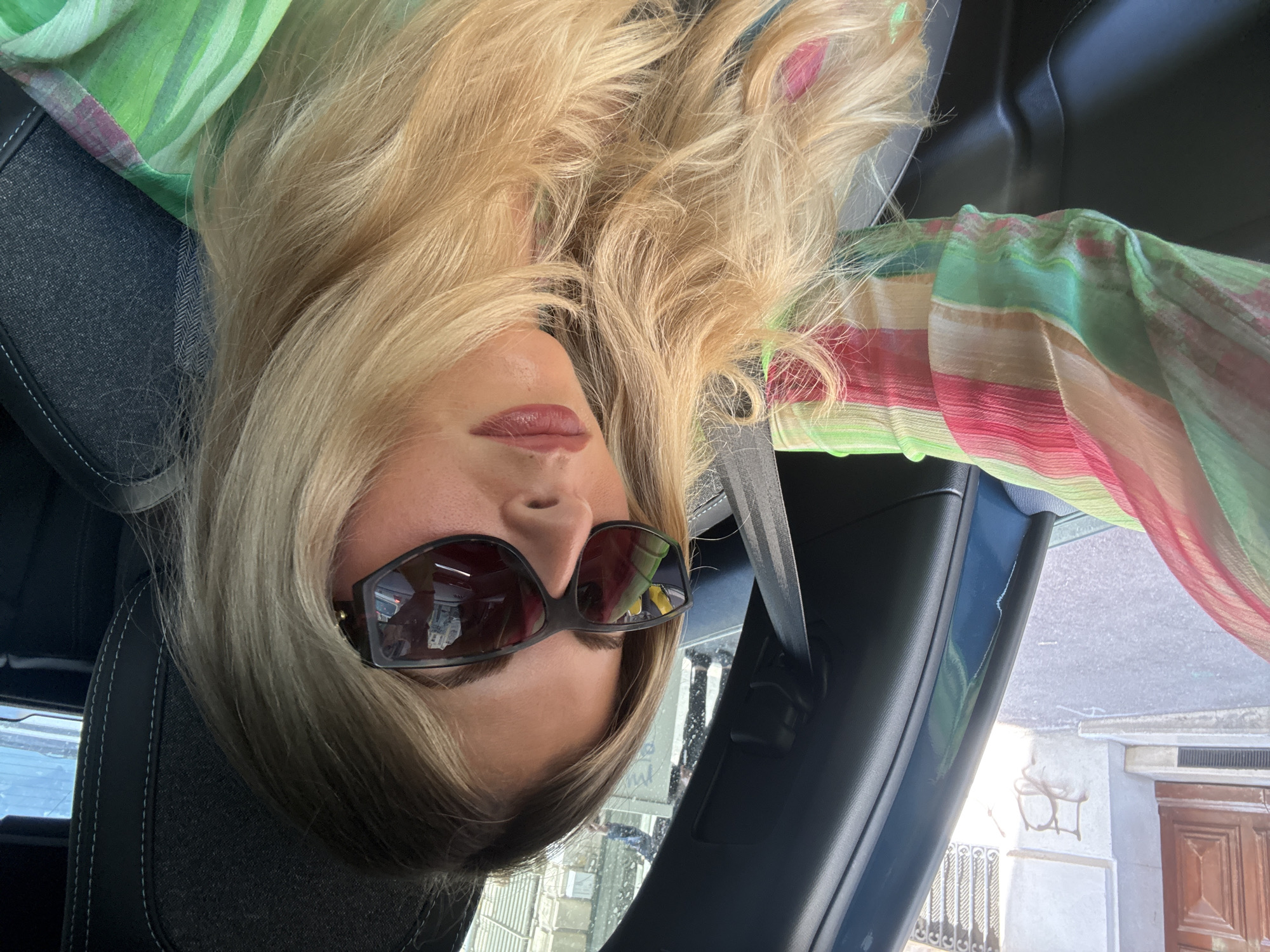 Woman in car observed on sunny Marseille street