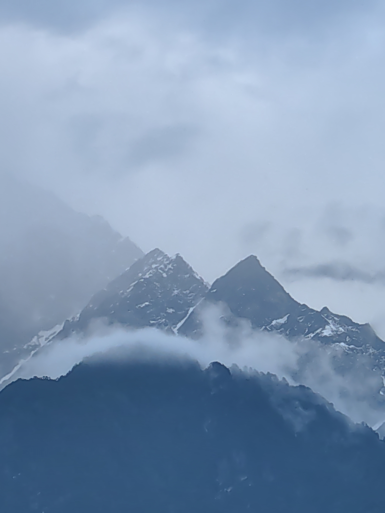 Misty mountain views across Vashisht village during cloudy afternoon