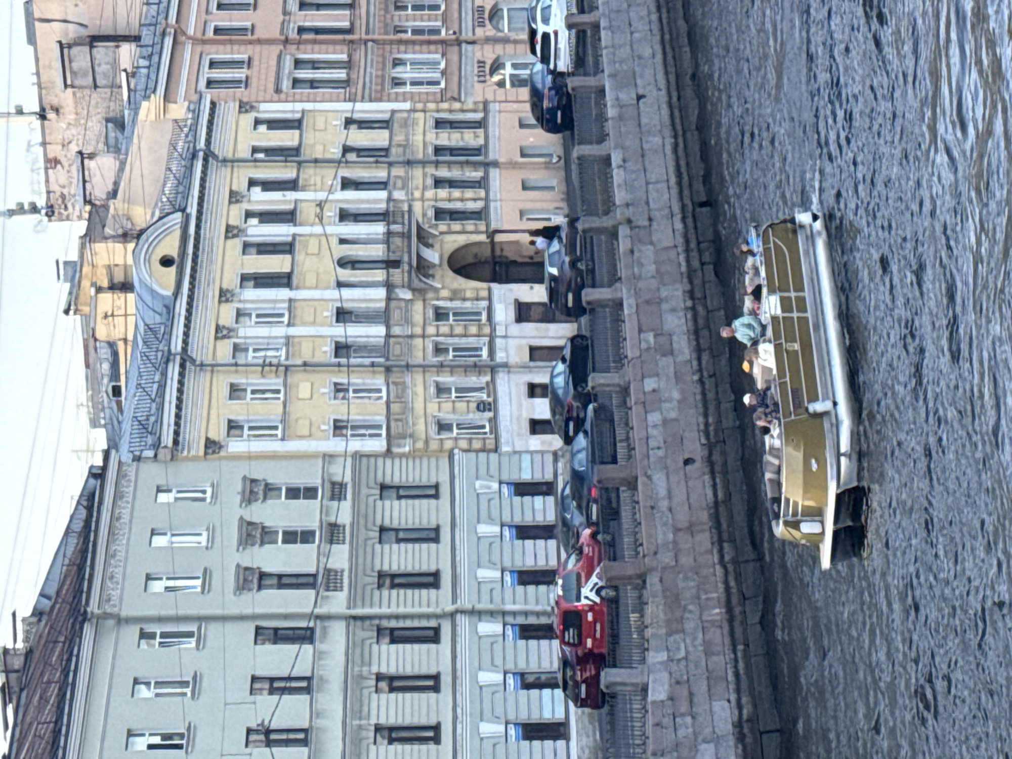 Tourist takes selfies during evening canal boat tour in Saint Petersburg