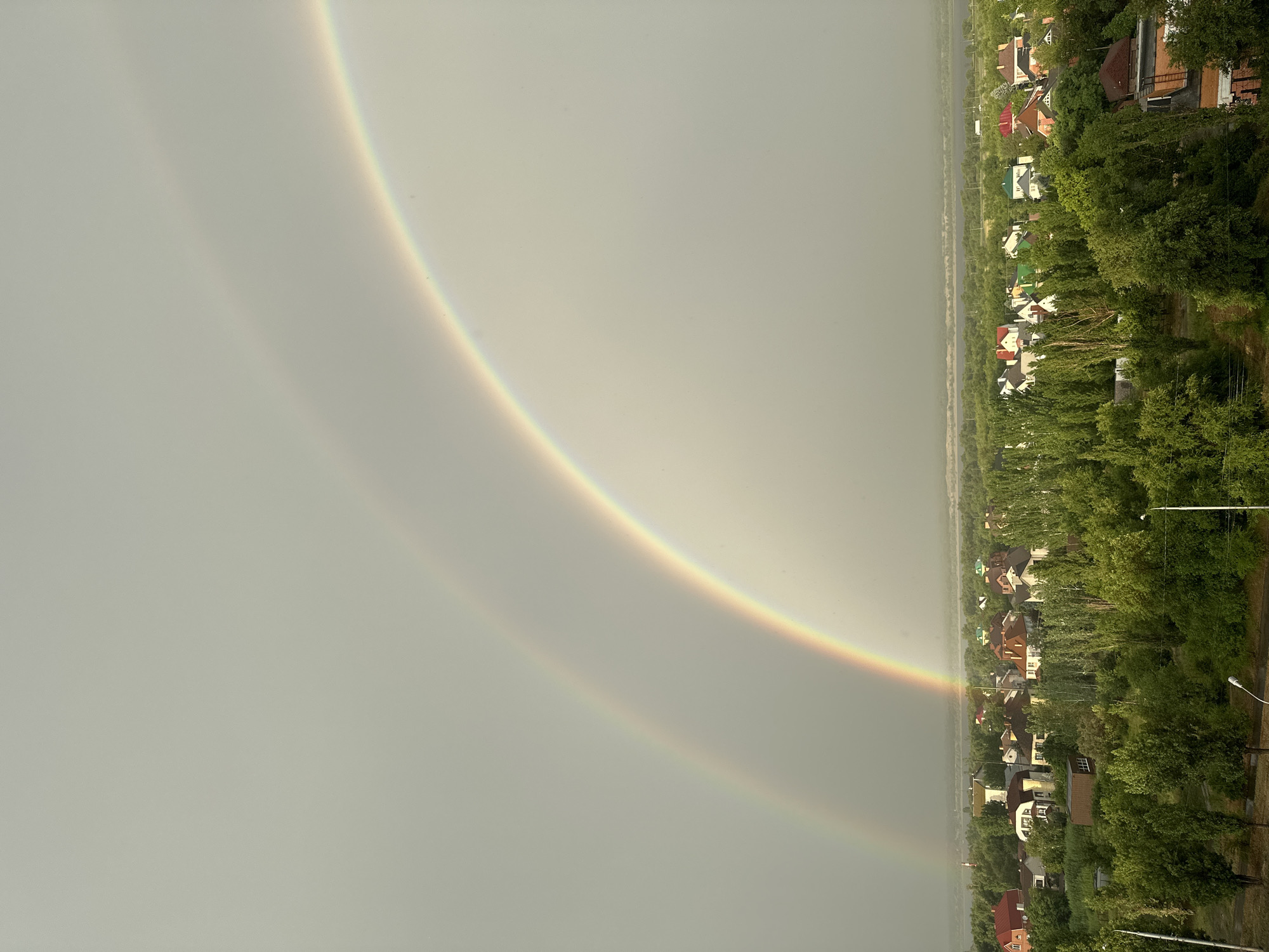 Double rainbow spans village and city skyline near Volgograd