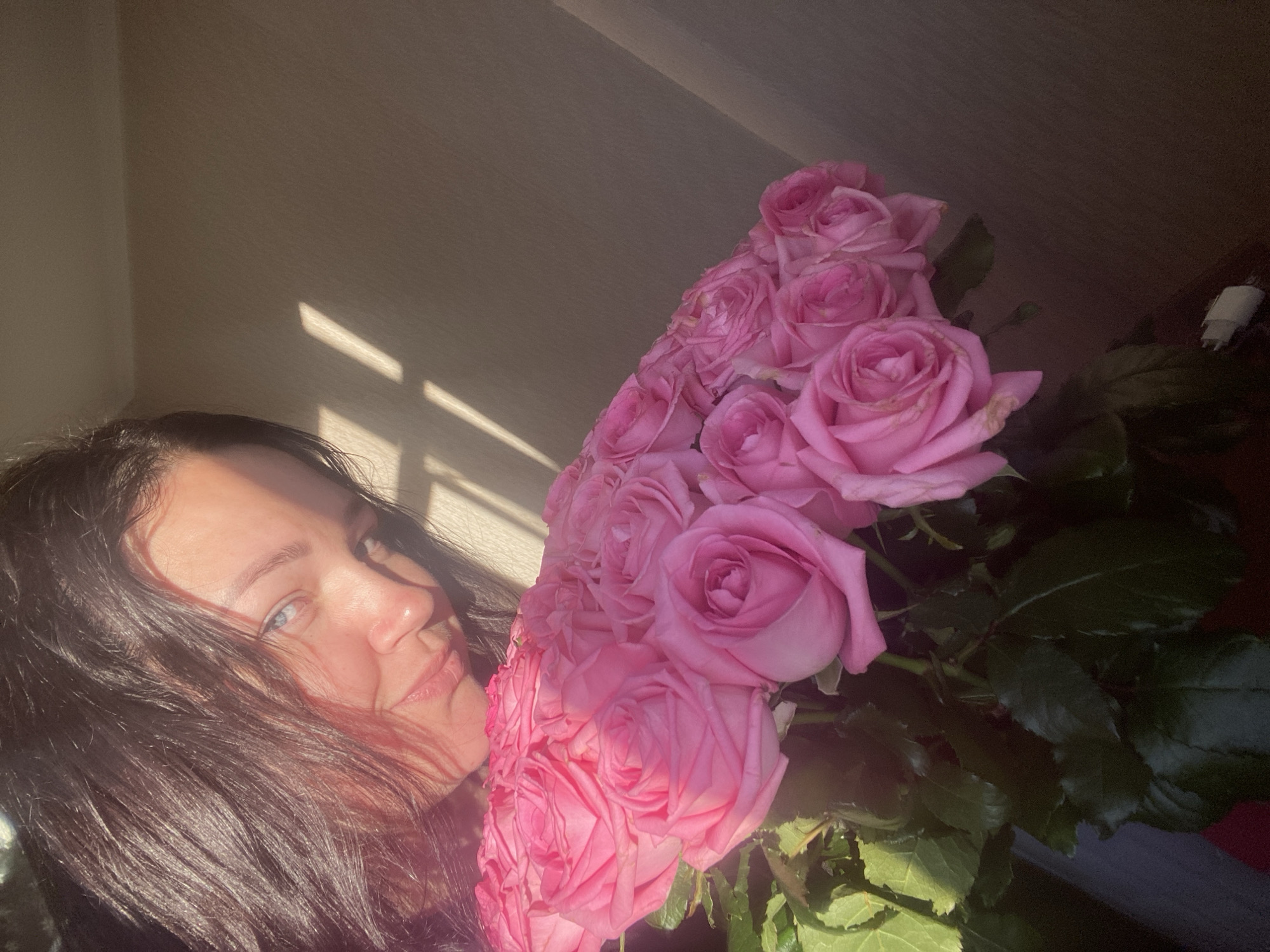 Woman receives pink roses in early morning Sochi scene