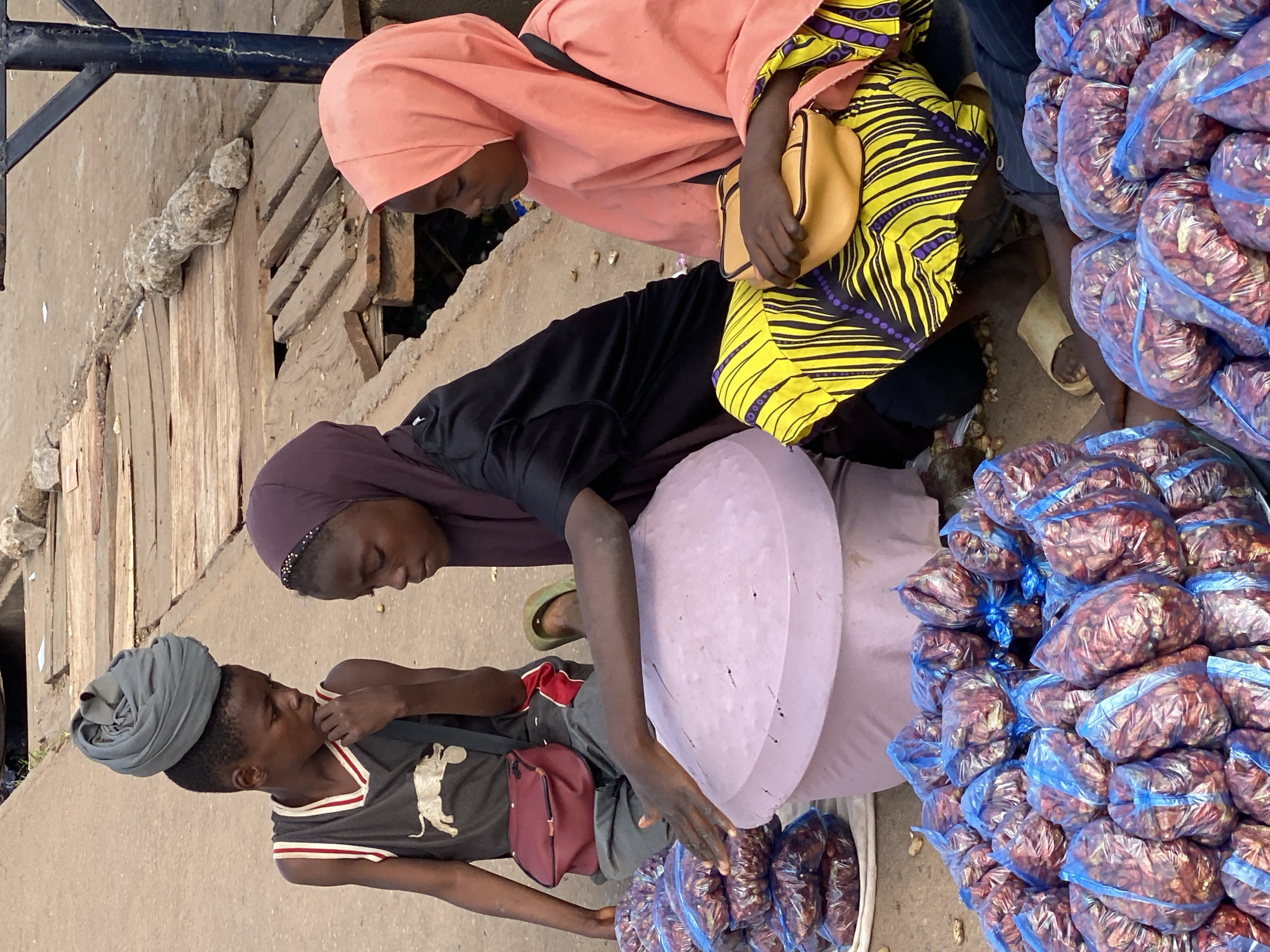 Street vendors and shoppers fill a Sabon Tasha market morning