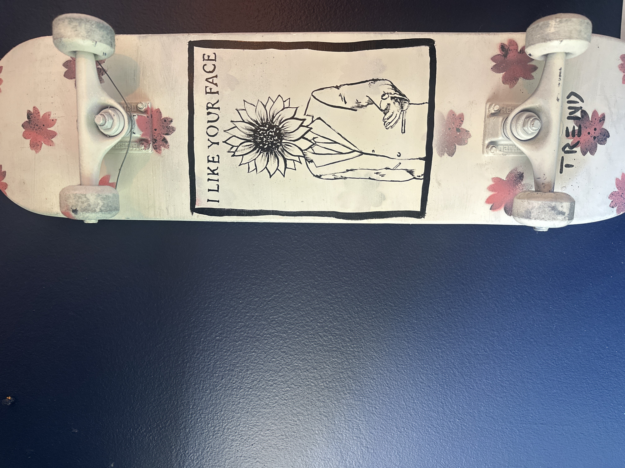 Woman photographs decorative skateboard display in Boca Raton home