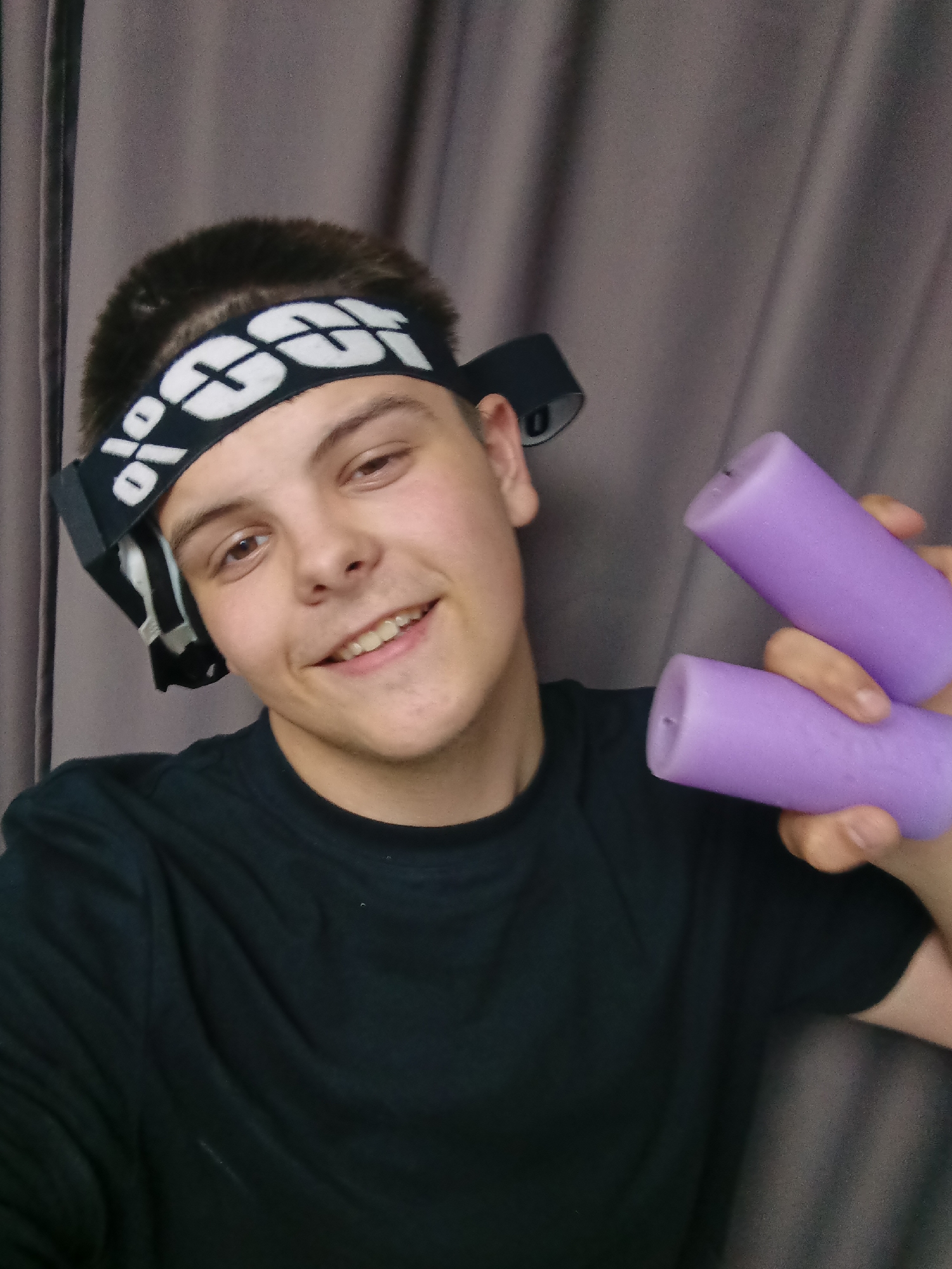 Young man poses with assorted objects in Russian photo session