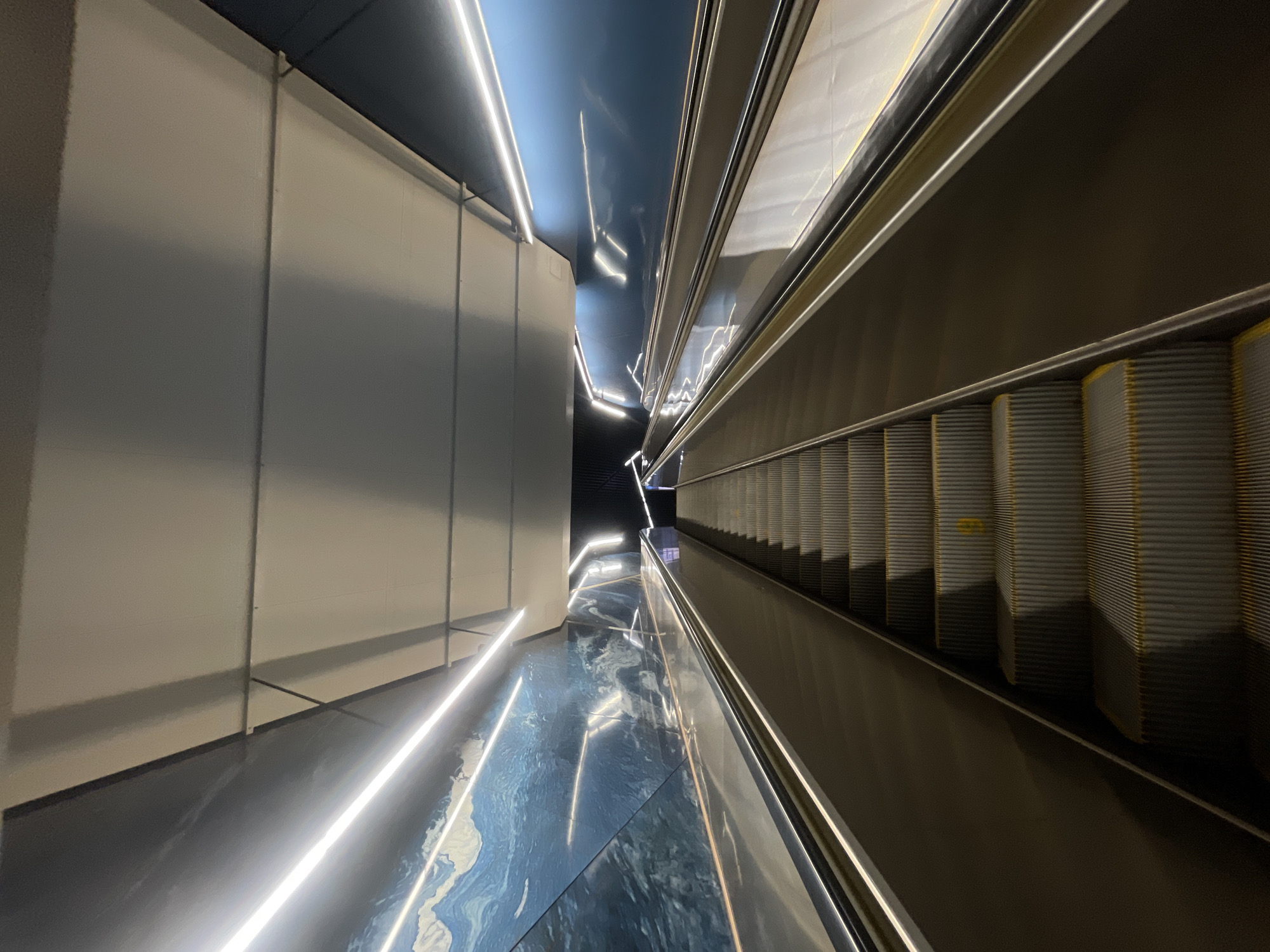 Subway escalators and a cable-stayed bridge on an urban afternoon