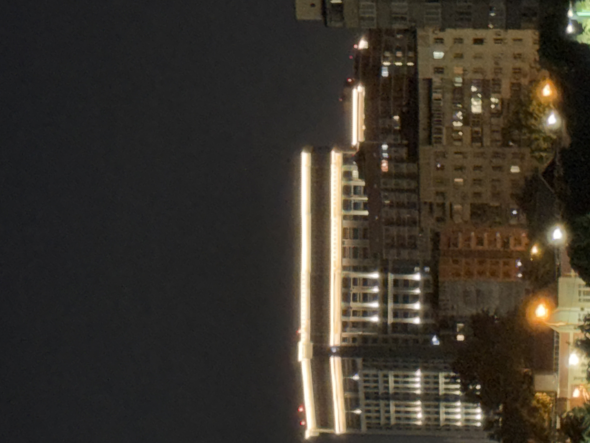Evening stroll through a lit urban plaza with architectural details